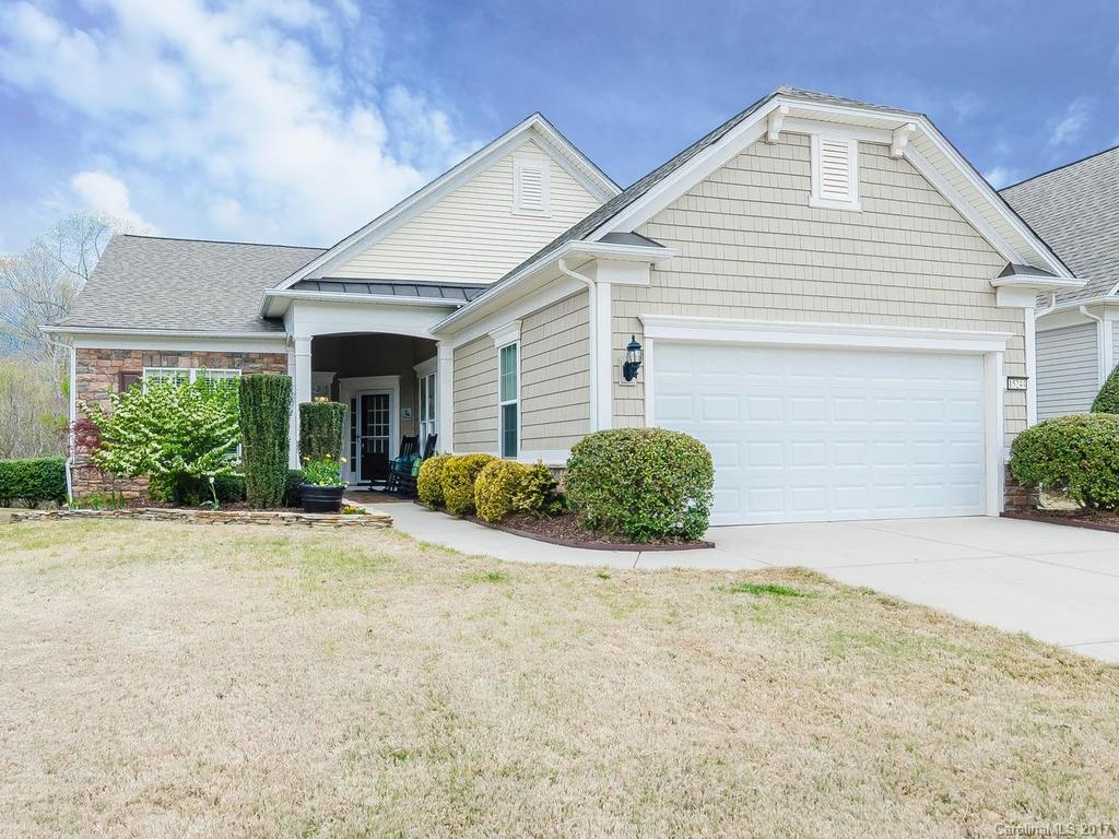 One of the prettiest lots in Sun City! From the screened porch, look into a thick green forest. You won't want to leave! This beautiful 2 BR/2 Bath w/office is spacious & bright. Open floor plan w/upgraded hardwoods. Roomy gourmet Kitchen w/granite, pullouts, stainless app, french door refrig, tile backsplash. Laundry has front-load stacked washer/dryer, sink.  Outdoor irrigation, beautiful stamped concrete porches and a remote control screen wall you have to see! There’s even more, come see it!