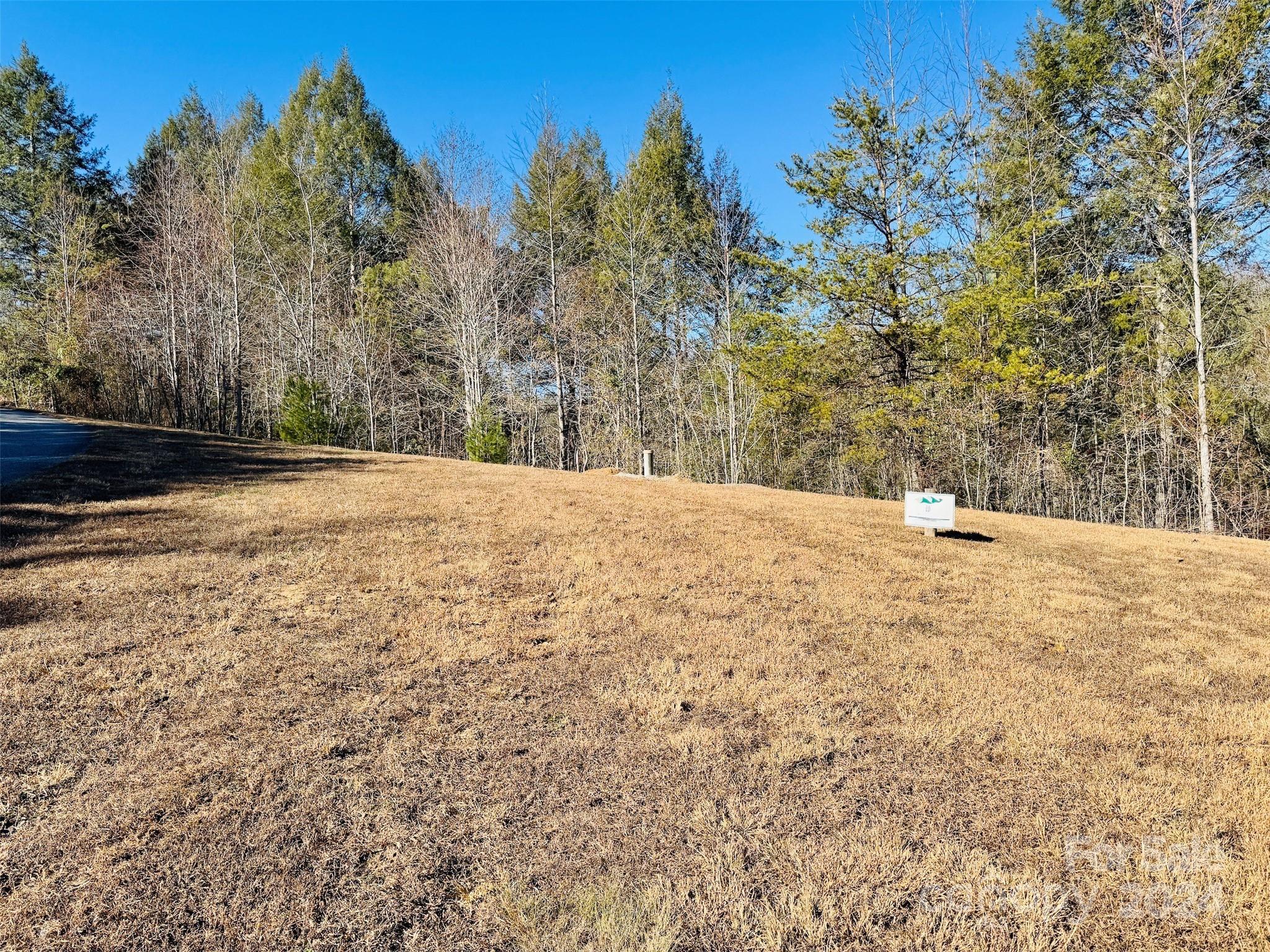 Build your dream home on 1.3 acres at The Coves Mountain River Club, an Outdoor Lifestyle Community like no other.  Seller including home plans and topo maps designed for the site.  The well for the home is installed and a 3 bedroom septic permit was obtained. The Coves is a 3,200 acre gated community on 5 miles of the Johns River, minutes from Lenoir, Blowing Rock, and Morganton NC and the Blue Ridge Parkway.  Hike, bike, ride horses/UTVs on miles of community exclusive trails.  The Coves is a Firewise USA® Community, a program of the National Fire Protection Association, that helps neighbors organize to reduce wildfire risk, harden homes, and create defensible space by managing vegetation and preparing for wildfires. Enjoy the post and beam constructed clubhouse on one of the highest peaks: panoramic views of the Brushy Mtns, Blue Ridge Mtns, and South Mtns; wrap around decks/porches on 2 levels, great room w/vaulted ceilings, 3-sided fireplace, kitchen, pool table, fitness center, locker rooms, outdoor fire pits.  Wyatt's Park has pickle-ball courts, putting green and picnic pavilion.  Additional amenities include 2 equestrian centers, more picnic pavilions, community garden and vineyard.  Over 30 clubs to join!