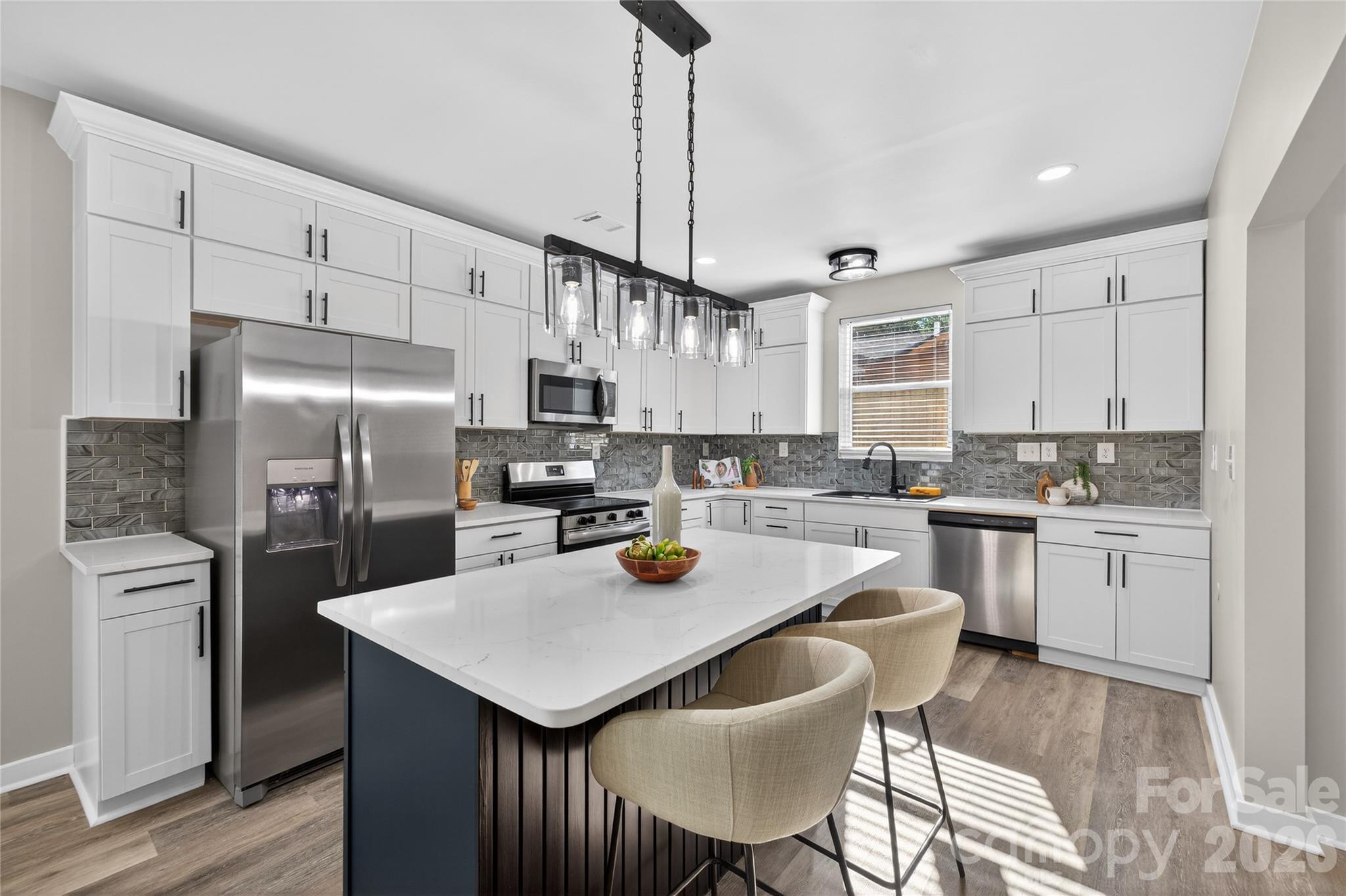 This thoughtfully updated home pairs clean, modern finishes with a layout that just makes sense.

Located minutes from Uptown Charlotte with easy access to Optimist Hall, Camp North End, and the NC Music Factory, the setting offers convenience to some of the city’s most popular dining and entertainment spots.

A wide, welcoming hallway enhances the sense of space and flow, while maintaining elements of the home’s original charm. The living space feels bright and connected, ideal for both everyday living and hosting. The renovation was done with intention- featuring all new flooring, updated lighting, quartz countertops, beautifully tiled showers, and new windows throughout.

Every detail was considered to create a cohesive, modern feel while maintaining a sense of warmth. Exterior updates include new siding and a newly installed privacy fence, rounding out the home’s complete transformation.