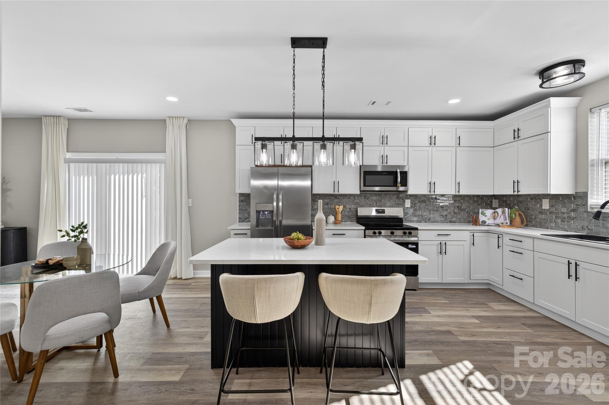 This thoughtfully updated home pairs clean, modern finishes with a layout that just makes sense.

Located minutes from Uptown Charlotte with easy access to Optimist Hall, Camp North End, and the NC Music Factory, the setting offers convenience to some of the city’s most popular dining and entertainment spots.

A wide, welcoming hallway enhances the sense of space and flow, while maintaining elements of the home’s original charm. The living space feels bright and connected, ideal for both everyday living and hosting. The renovation was done with intention- featuring all new flooring, updated lighting, quartz countertops, beautifully tiled showers, and new windows throughout.

Every detail was considered to create a cohesive, modern feel while maintaining a sense of warmth. Exterior updates include new siding and a newly installed privacy fence, rounding out the home’s complete transformation.