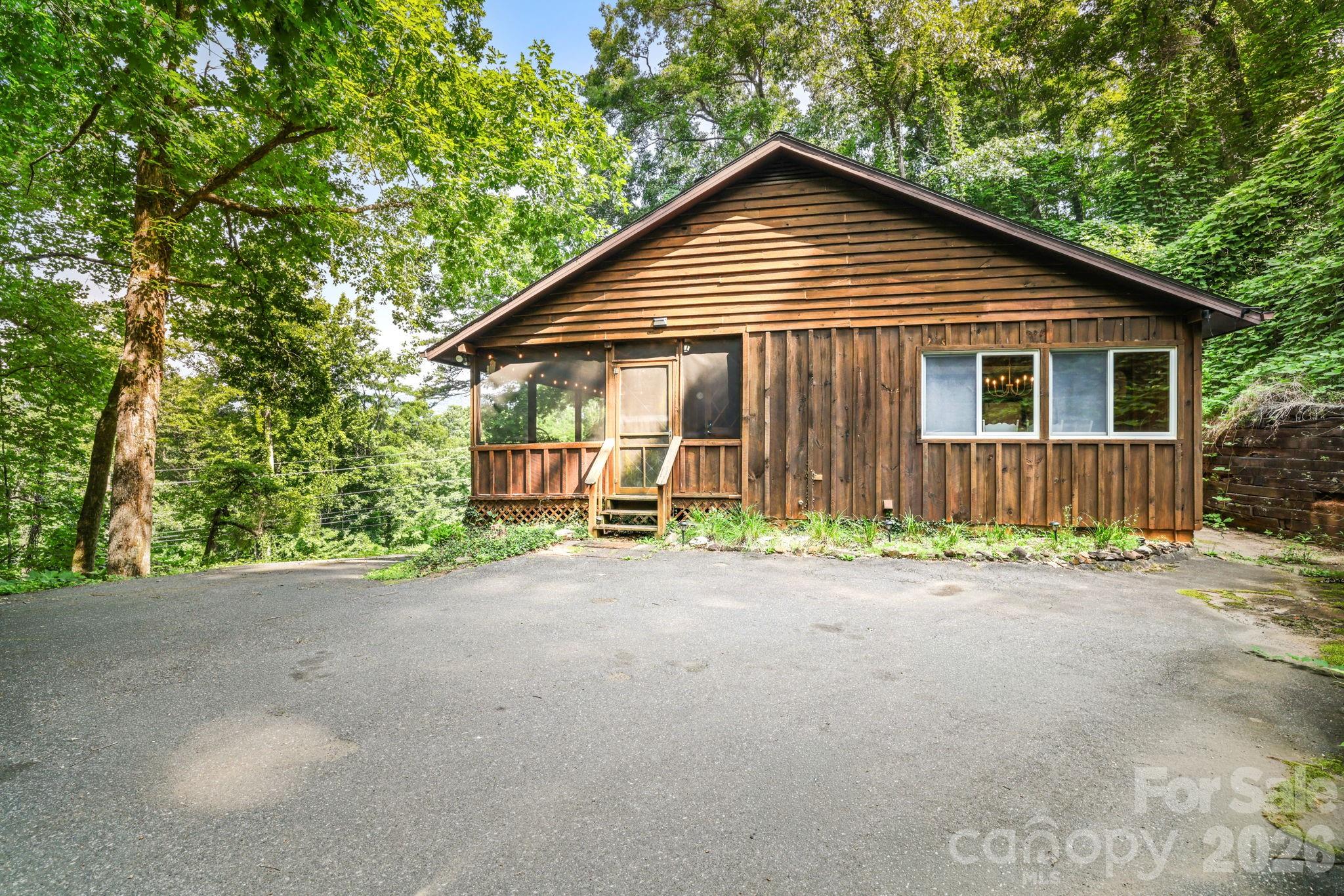 Being sold fully furnished! This well-maintained 2-bedroom, 1-bath mountain cabin sits on a 0.41-acre lot with easy paved access just minutes from downtown Bryson City. The open-concept floor plan features a stunning stone fireplace, creating a warm and inviting living area. Relax on the covered front porch, entertain on the spacious deck, or unwind in the private hot tub after a day of mountain adventures. Ideally located near the Great Smoky Mountains Railroad, Deep Creek, the Nantahala Outdoor Center, Harrah's Cherokee Casino, hiking, fishing, rafting, shopping, and dining. Whether you're searching for a full-time residence, a peaceful mountain retreat, or a turnkey vacation rental investment, this charming cabin offers an exceptional opportunity in a highly desirable location.