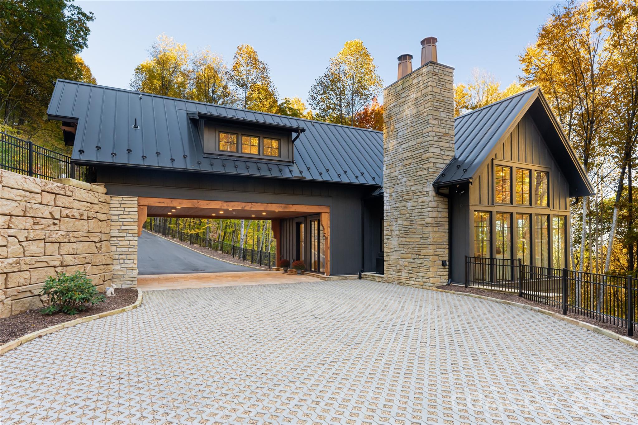 Reflecting the rarity and immediate lifestyle appeal of this fully furnished mountain offering, 256 Haulback Way presents an exceptional opportunity within the gates of Balsam Mountain Preserve. Perched at approximately 4,000 feet in the heart of the Blue Ridge Mountains, this remarkable property pairs a Morgan-Keefe custom-built guest residence with a premier future estate homesite, allowing buyers to immediately embrace elevated mountain living while envisioning a legacy retreat surrounded by breathtaking natural beauty.

Designed with a sophisticated balance of luxury and warmth, the residence is a refined sanctuary where architecture and nature exist in harmony. Expansive floor-to-ceiling glass captures sweeping mountain vistas and abundant natural light, while vaulted interiors, a striking stone fireplace, curated designer furnishings, and a gourmet kitchen create an effortless environment for both entertaining and everyday living. Modern conveniences including EV charging, fiber internet, generator, integrated Cat6 wiring, and smart-home capabilities further enhance the seamless ownership experience.

Across a gently flowing mountain stream, the future homesite offers exceptional privacy and the opportunity to create a custom mountain estate within one of Western North Carolina’s most coveted private communities. Encompassing approximately 4,400 acres with nearly 75% protected conservation land, Balsam Mountain Preserve offers an unparalleled lifestyle centered around nature, wellness, and recreation.

Community amenities include an Arnold Palmer Signature golf course, equestrian center, wellness and fitness facilities, hiking and biking trails, fly fishing along a Class A trout stream, luxury dining and social experiences, and a prestigious 24-hour staffed guard gate—all ideally positioned within the Great Smoky Mountains of Western North Carolina.
