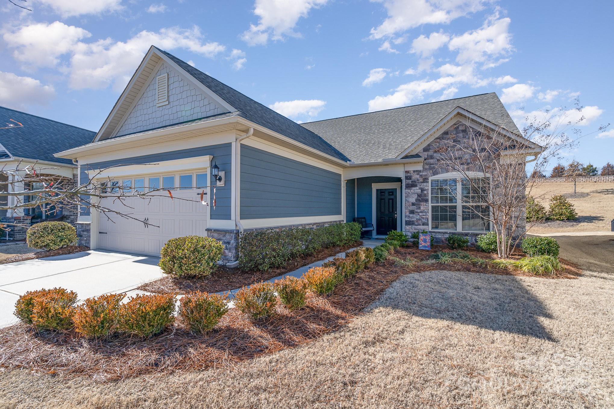 Nestled in the prestigious 55+ Carolina Orchards community, this exceptional 3-bedroom, 3-bath Castle Rock model with private backyard & near culdesac. The open kitchen is a chef’s dream, featuring granite countertops, a grand island, high-end stainless steel appliances, & a gas range & upgraded walk-in pantry. The serene primary en-suite offers w/ a walk-in shower, dual vanities, & a custom-designed closet. The home is further elevated w/ a gas fireplace, kitchen drybar, lvp floors & a bright office w/ French doors and  transom window.. A guest suite is conveniently located on the main floor! Upstairs, find an expansive loft, guest suite w/ private bath & versatile flex room! The screened-in porch is perfect for relaxation, while the low-maintenance yard, cared for by the HOA, ensures effortless living. Enjoy world-class amenities including pools, fitness center, sports courts, & a dog park. Located  near shopping, dining, & the scenic Anne Close Greenway!
