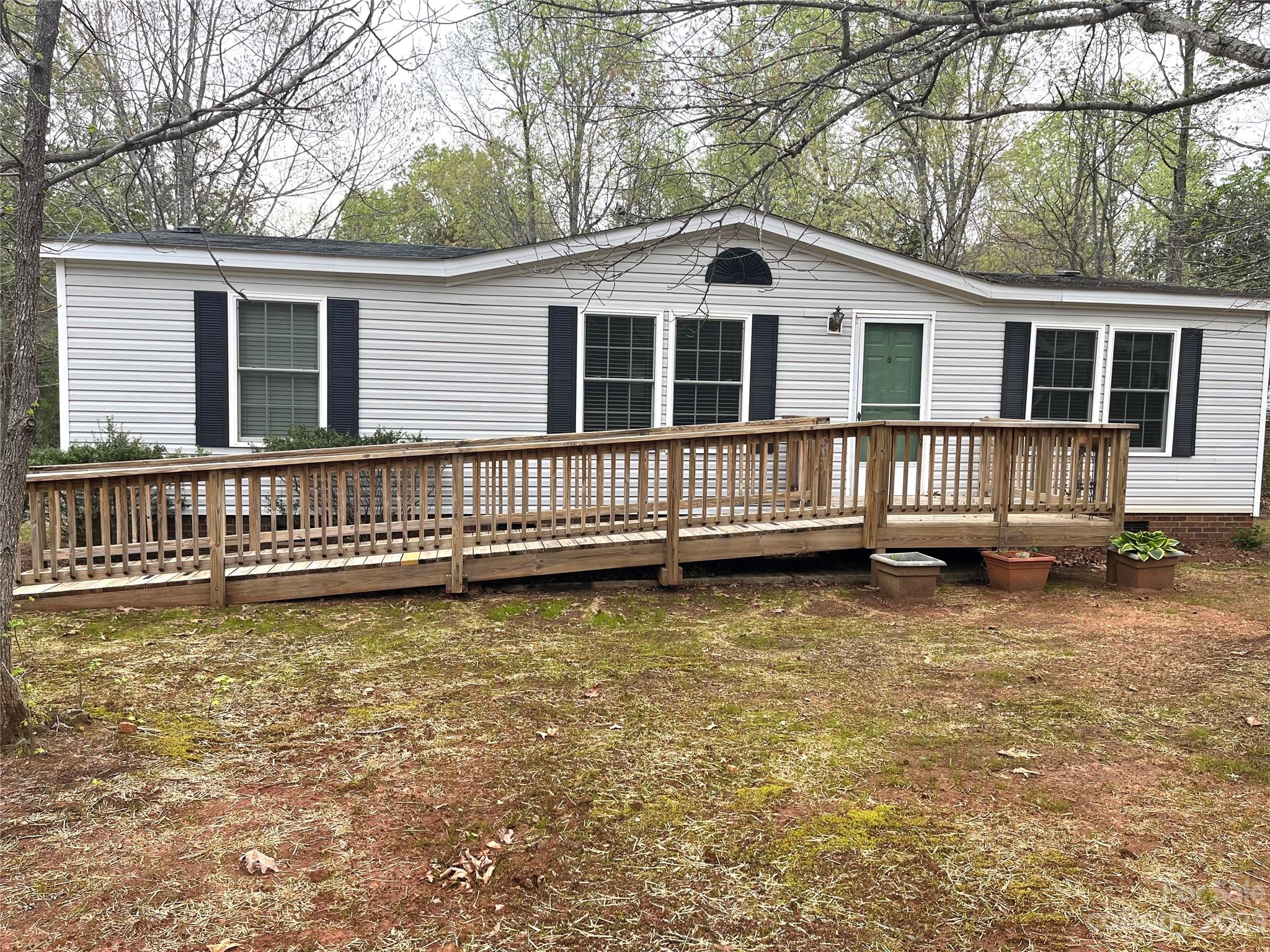 Welcome Home! This lovely 3 Bedroom, 2 Bath well kept double-wide home is located on just under 2 acres near thriving downtown Waxhaw! This home has a huge open living space, a breakfast area and a kitching with lots of luxurious cabinets and spacious counter space. The primary bedroom offers a huge private bathroom with dual vanities. The deck space will be great for outdoor entertaining. Convenient to all the attractions and amenities such as restaurants, breweries, shopping and medical. Unlimited potential!