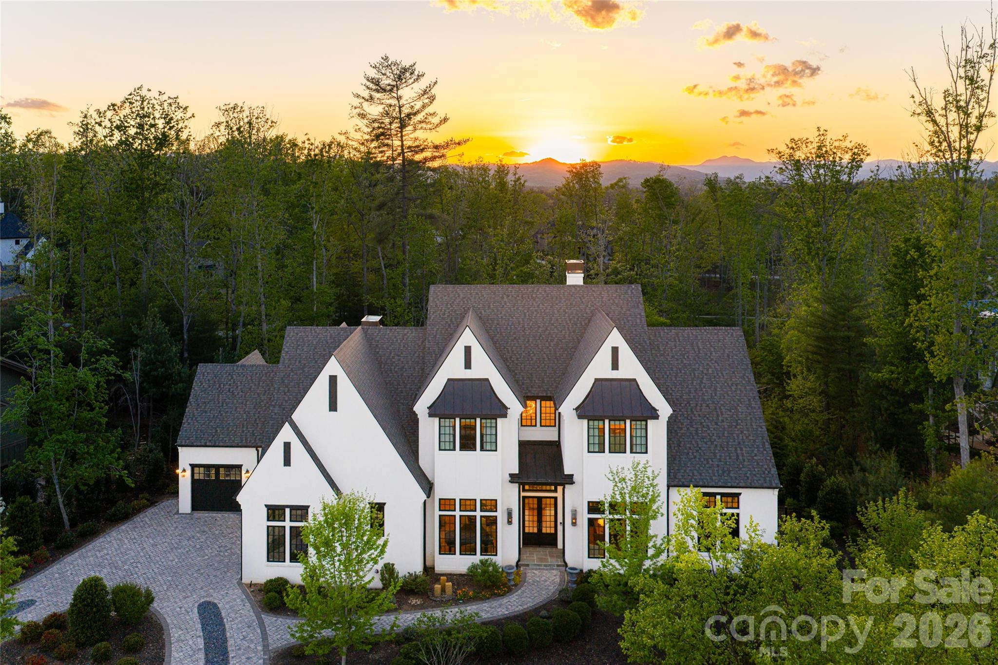 Tucked in the desired enclave of the Ramble, this distinguished European-inspired residence offers a refined balance of architectural elegance and effortless livability. Bathed in natural light, the home is defined by an abundance of windows that frame serene surroundings while illuminating every thoughtfully designed space. A dramatic sense of volume unfolds upon entry, where soaring vaulted ceilings and an airy, lofted upper hall create a striking visual connection between levels. The open railing above lends dimension and intimacy, enhancing the home’s graceful flow. At the heart of the residence, a gourmet kitchen invites everyday living and elevated entertaining, seamlessly blending function with timeless style. An elevator is in place for living on all levels. Just near the kitchen is a private screened porch for enjoying the overview of the property. The main-level primary suite is a private sanctuary, crowned by cathedral ceilings with exposed beams that evoke understated grandeur. Its spacious bath offers a spa-like retreat, designed for comfort and quiet indulgence. The lower level expands the home’s lifestyle appeal with an incredible wine cellar, generous recreation area, complete with a media lounge and wet bar, and gym, ideal for hosting or unwinding. From here, doors open effortlessly to the pool, creating a seamless indoor-outdoor experience ideal for year-round enjoyment. Residents of the Ramble enjoy access to an array of exceptional amenities, enriching daily life with leisure and community connection. This is a home where elegance, light and thoughtful design converge, offering a living experience as inspiring as it is enduring.