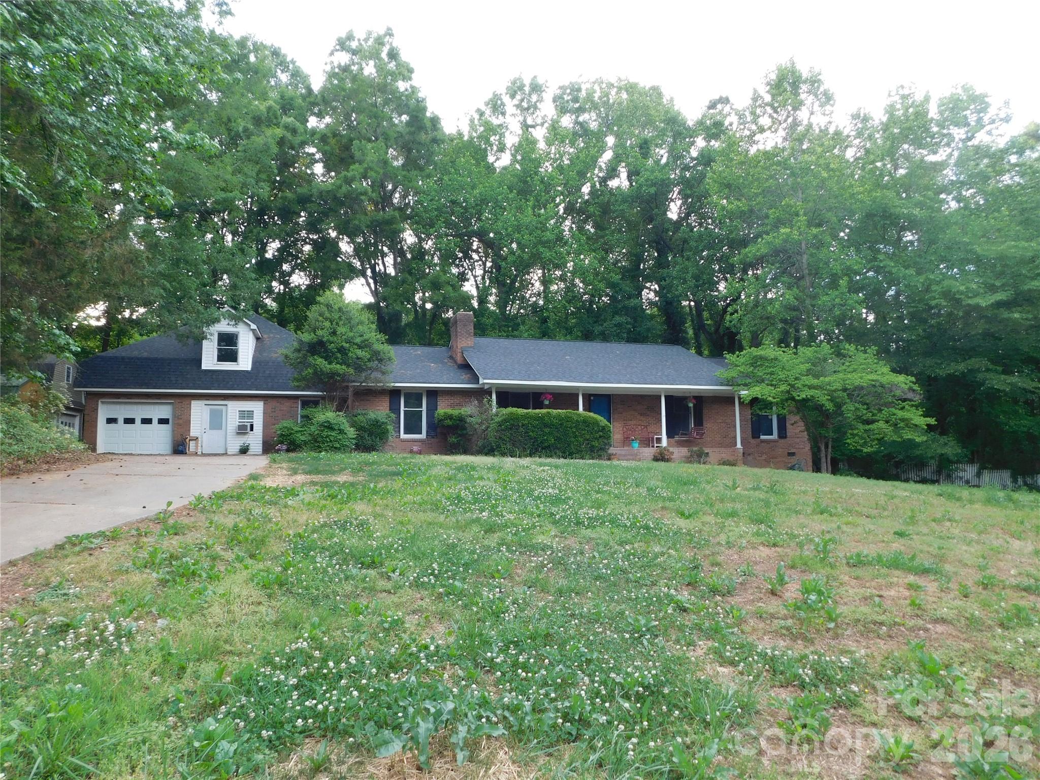 Great location with 3.62 acres in northern Union County, NC.  Only minutes from Unionville/Piedmont Schools, this brick ranch has 4 bedrooms, 3 full bathrooms, approx 2829 HSF. Interior has new flooring, new paint, new kitchen countertops. New roof, new HVAC units. Nice open floor plan. Finished room over garage has 637 SF. One side of the two car garage has been enclosed but could easily be renovated back to original two car garage. Multiple storage buildings.  Home still needs some TLC but great potential to make it suit your own style.