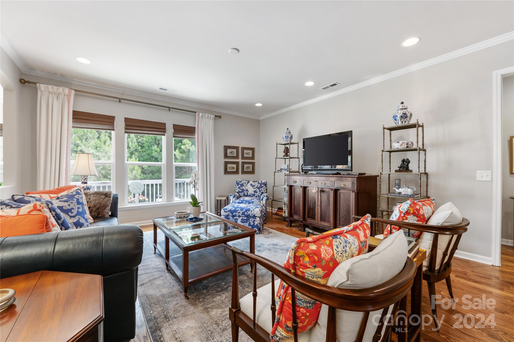 Weekend guests? Hobbies? This is the one for you. Located on a cul-de-sac in the heart of Sun City, this home features a bright, open floorplan w sunroom upgrade AND a finished basement! A chef’s kitchen boasts light cabinets, granite counters & stainless appliances. The kitchen flows into a dining area, great room, & sunroom. It has REAL hardwood floors, extensive moldings, updated light fixtures. The primary suite, in the rear of the home, offers a tray ceiling, a walk-in closet, & lovely private natural views. A 2nd BR, full bath, & office/den w glass doors are also on the main level. The finished bsmt incl a spacious living area, a bar w beverage fridge & an additional full bath & bedroom w a sitting area. There is also a flex room & an unfinished storage space. Enjoy outdoor living w a lower level patio, covered front porch, & a deck off the sunroom overlooking a private, tree-lined yard. Sun City offers endless activities—pickleball, tennis, fitness, pools, garden, clubs, & more!