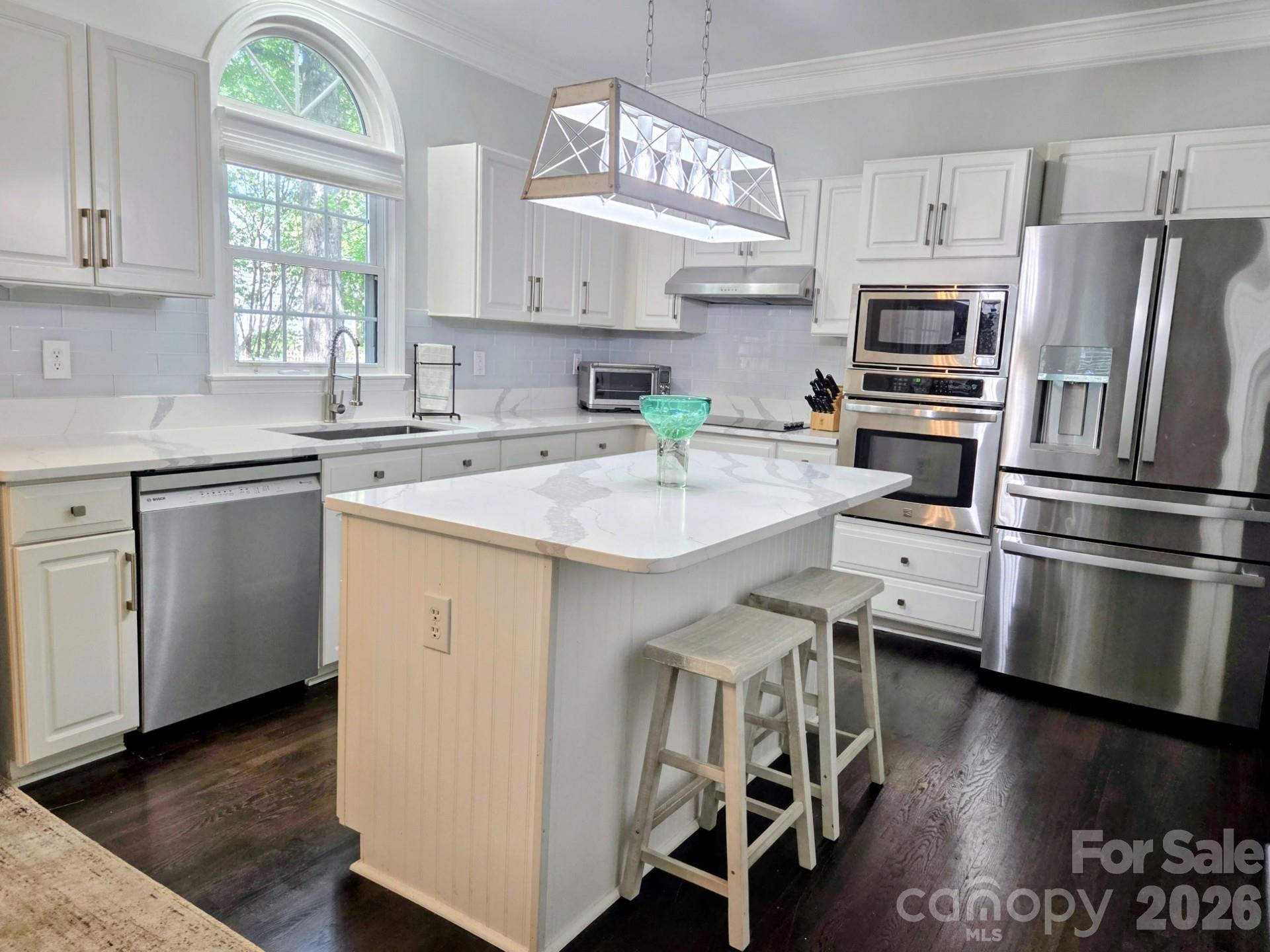 Many Upgrades Include New: Bosch Dishwasher, Moen Disposal, 50 Gallon Hot Water Heater, Expansion Tank, Pressure Reducing Valve, Long Neck Designer Faucet, 2 Faucets in the Primary Bath and Powder Room, etc. Most of the Interior has Fresh Paint. The Kitchen Cabinets have recently been Refurbished and the Soft Close Feature was added throughout. Enjoy White Quartz Countertops in the Kitchen, Center Island, Desk, and Primary Vanity. Other Features include SS Appliances, 9’ ceilings, Plantation Shutters, Large Crown Molding, Designer Lighting and Built In Cabinetry on Main. The Open Floorplan Features The Great Room with Plenty of Natural Light. This Room also Connects to a Screened Porch with 2 Ceiling Fans and Indoor Outdoor Carpet. There is also an Office on Main which could be used as a Playroom. There is an Oversized Garage for your " Toys ". A Main Selling Point is the Large Addition Upstairs which can be used as a 6th Bedroom/Workout Room/Playroom/Flex Room. Too Much to List. Please See the Build Sheet under the MLS Attachments for Upgrades. The Back Yard is Mostly Flat. The McAlpine Creek Walking Trails are about 2 Blocks away and goes on for miles. Top Rated Schools and Ballantyne Ridge is the New High School for this Listing. Possible Owner Financing with 400k – 500k down. Contingencies will also be considered.