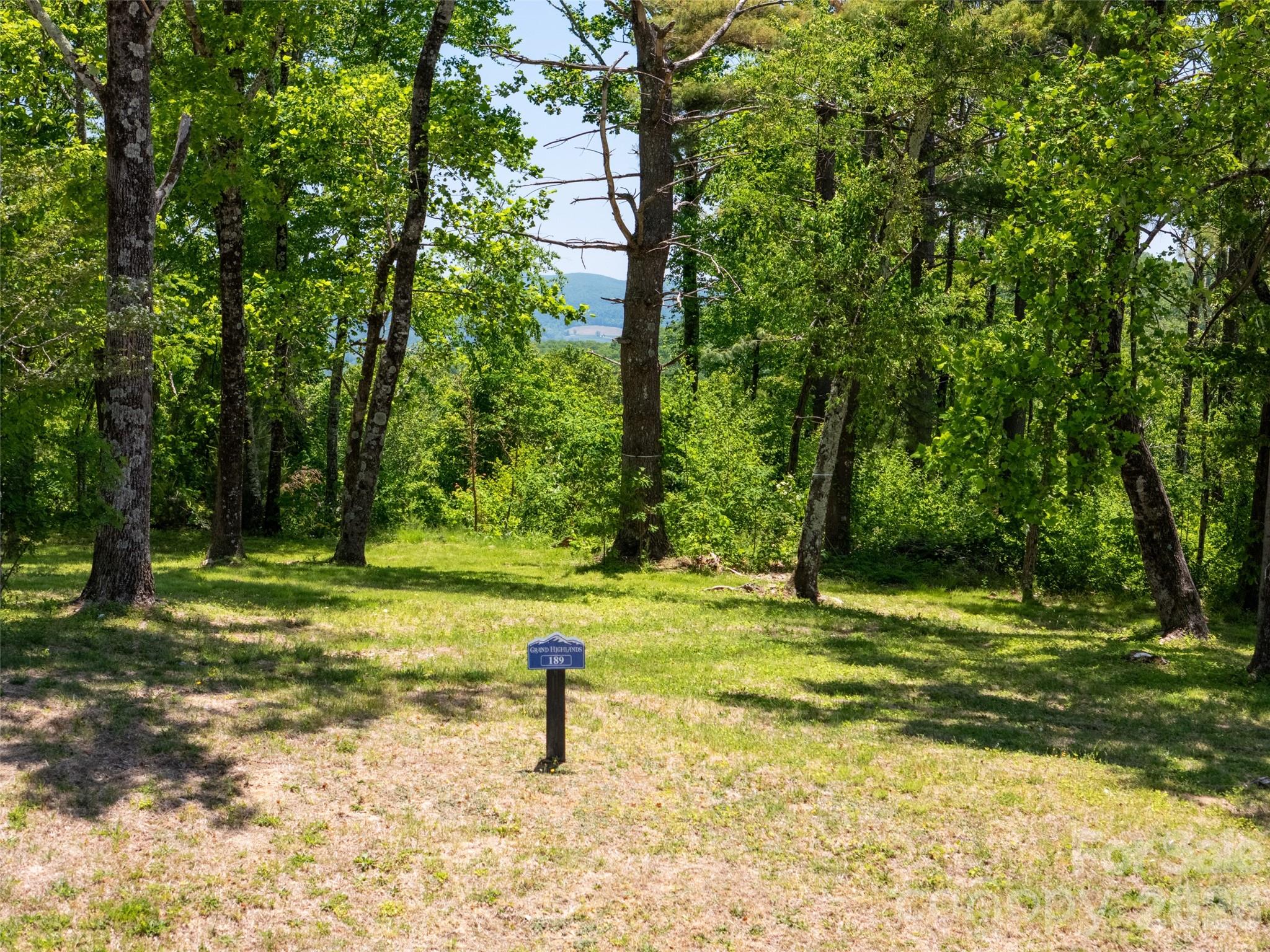 Perched at the top of the mountain, this exceptional 1.25+ acre homesite delivers the kind of sweeping, 180-degree long-range views that simply never get old. From sunrise to sunset, the horizon becomes your daily masterpiece. Unlike many mountain properties, this lot offers a rare and highly desirable gentle, build-friendly topography, making it easy to bring your vision to life without the usual challenges of steep terrain. The unique pie-shaped layout provides both privacy and flexibility, allowing you to perfectly position your home to capture the full panoramic view. Enjoy the best of mountain living with the convenience of modern infrastructure, including access to city water and high-speed fiber optic internet. This property is a standout opportunity to build on one of the most usable and scenic lots available in the premier big mountain view community of Grand Highlands. 

Big views. Easy build. Endless potential.
