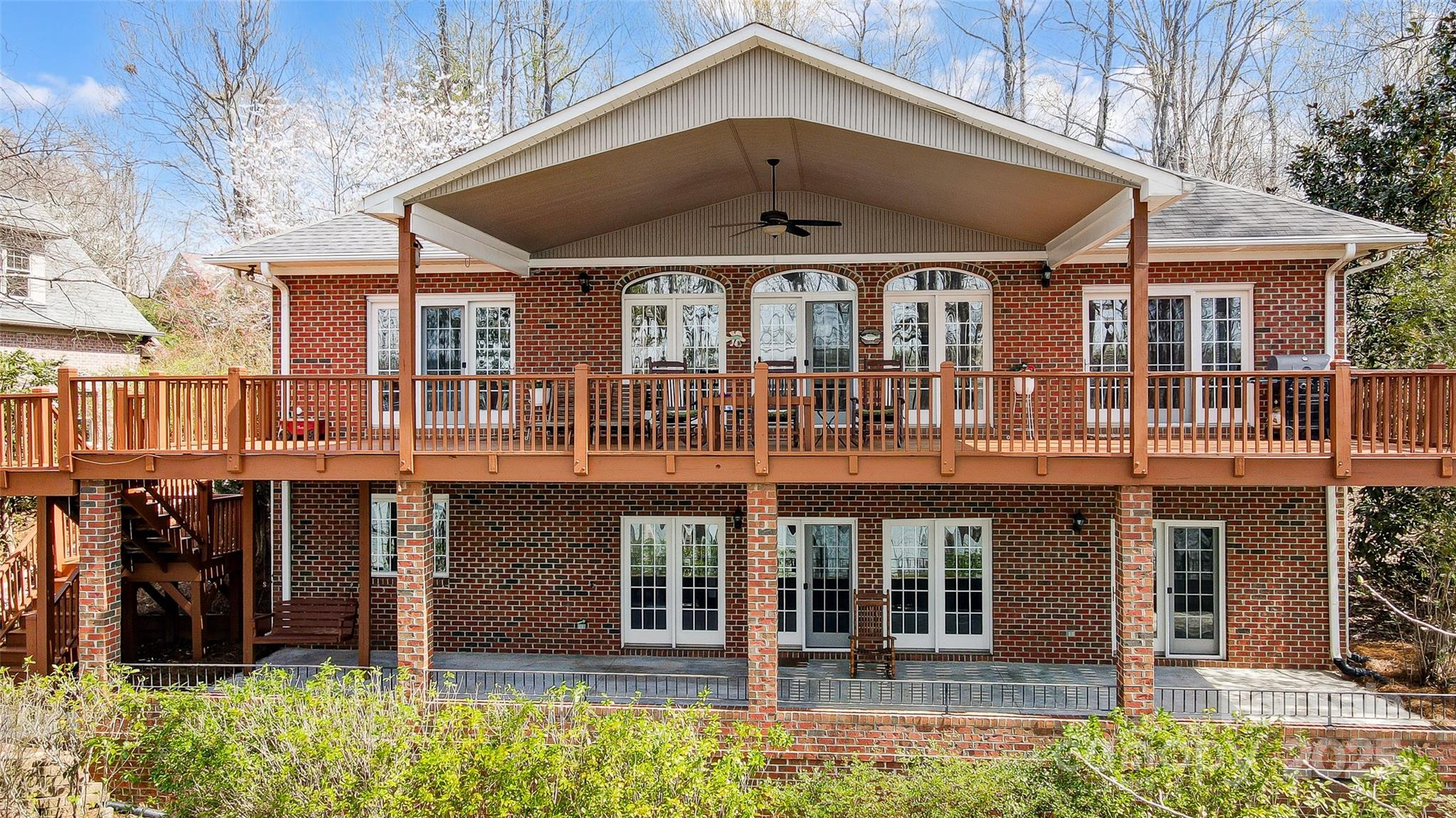 Step into a world of breathtaking lake views in this thoughtfully built brick custom home on Lake Wylie's main channel. Imagine entertaining in your private outdoor oasis, featuring a massive deck, covered porch, patio, lush landscaping, & covered dock w/ lift – the perfect launchpad for your boating adventures. The thoughtfully designed main level features a luxurious primary suite, 2nd bedroom with full bath, a light-filled great room with soaring ceilings, 2-sided fireplace, & stunning lake views.  A formal dining room complements the kitchen, equipped w/ Stainless steel appliances, ample counter space, cabinet storage, & pantry.  The lower level is a complete 2nd living quarters, featuring a full 2nd kitchen, 2 bedrooms, full bath, spacious living room, tons of storage, & versatile flex space that can be adapted to your needs.  Enjoy the "Away from it all" feeling yet only a short drive to Uptown, airport, I485 & I85.