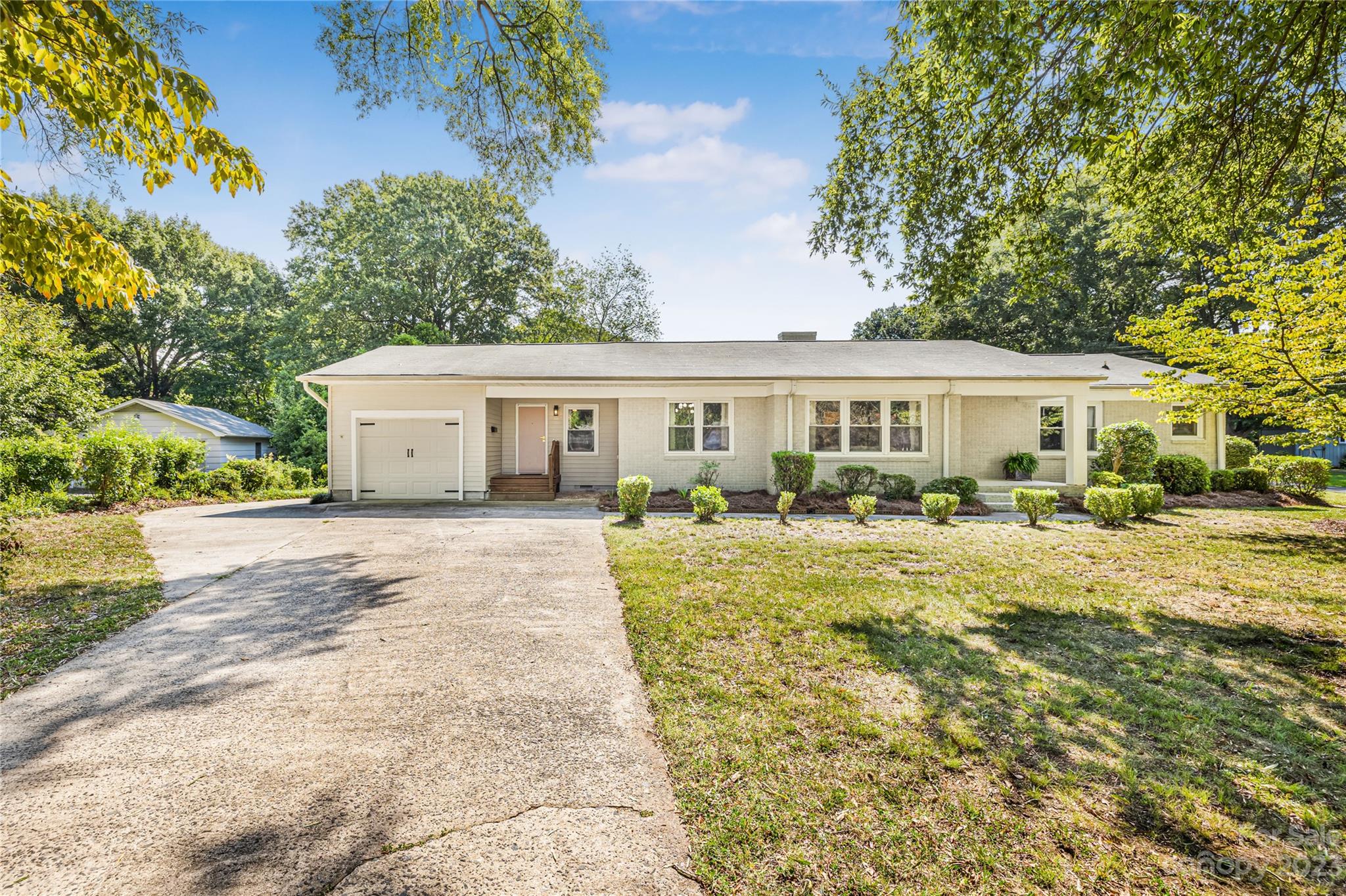 A renovated ranch located in sought after Roland Park neighborhood! This stunning brick ranch home has been fully renovated and features 3 bedrooms plus a bonus room/den, 2 custom bathrooms, 2, 1-car garages, and a shed, all situated on a large 0.40-acre lot with mature trees. The interior has been updated with refinished hardwood floors, stainless steel kitchen appliances, new kitchen countertops, new bathrooms, new lighting, new tankless water heater, and fresh interior and exterior paint. The large flat yard is perfect for outdoor activities and entertaining (with room for a pool!), and the cozy wood burning fireplace in the living room is ideal for chilly evenings. Located just minutes away from I-85, Eastridge Mall, and Franklin Square Shopping Center, this home offers easy access to shopping, dining, and entertainment. Don't miss out on this rare opportunity to own your dream home in Roland Park!  No HOA! Seller is open to changing paint colors, please reach out for incentives!