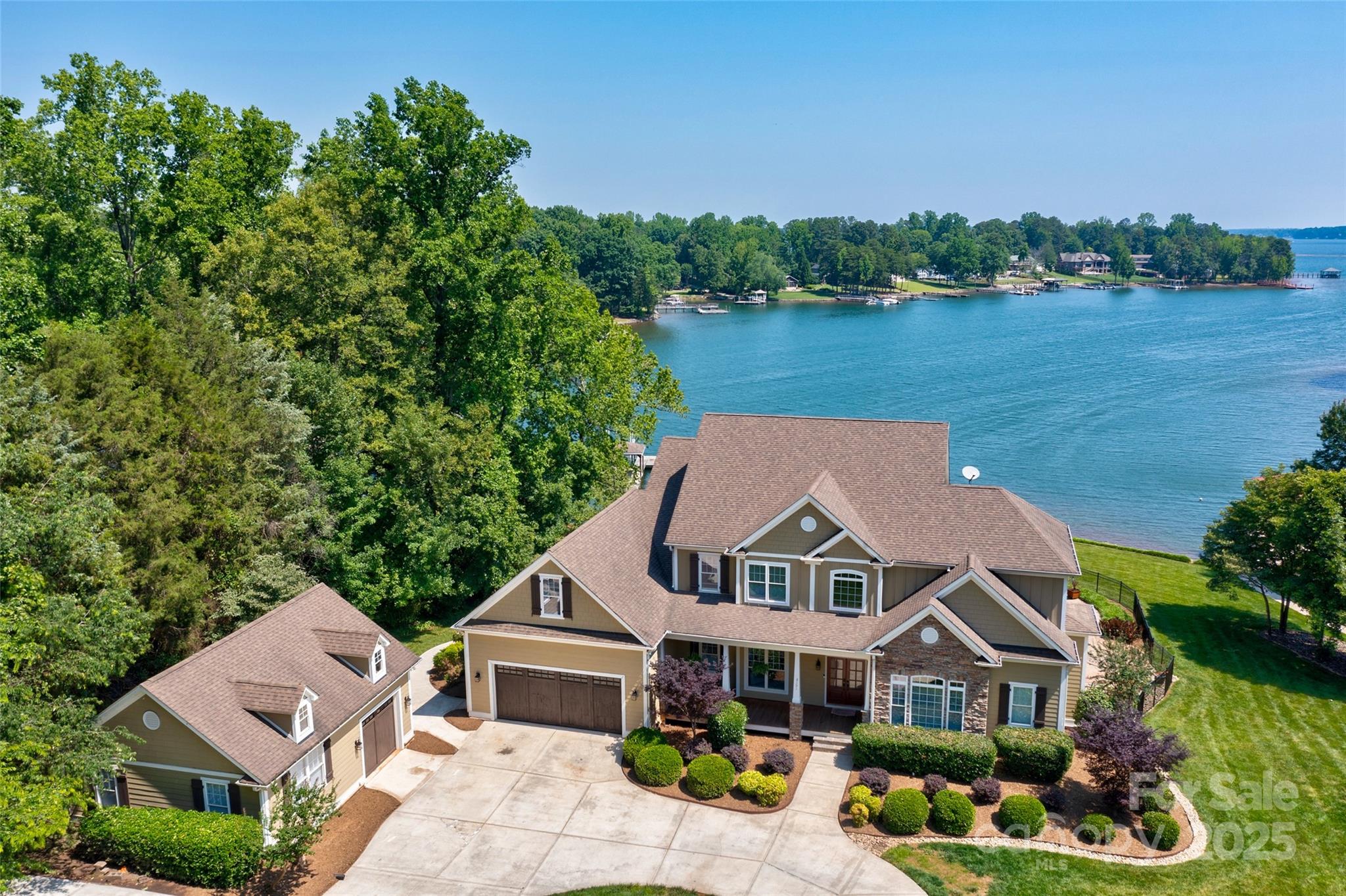 Stunning Waterfront Property w/Long Range Views of the Main Channel! Huge kitchen featuring a beautiful sunroom set up for dining with amazing views!. The large covered upper deck is perfect for entertaining and relaxing.  Luxurious Main Lvl Primary Suite features FP, two large walk-in closets, dual vanities, beautiful tile and more... The lower level has a designated office space with ensuite, media/game room, large Rec/LR with FP, 2nd full kitchen and dining area.  This level has access to the backyard, pool area, covered patio with more spectacular views! Outside features a beautifully landscaped pool area, inground salt water pool (not heated), covered patio area, covered dining area and fire pit.  The dock and private beach are steps away where you can launch kayaks, paddleboards or jump on your boat and go. Looking for a Second Home w/proven vacation rental income look no further than this beauty.  NO HOA!