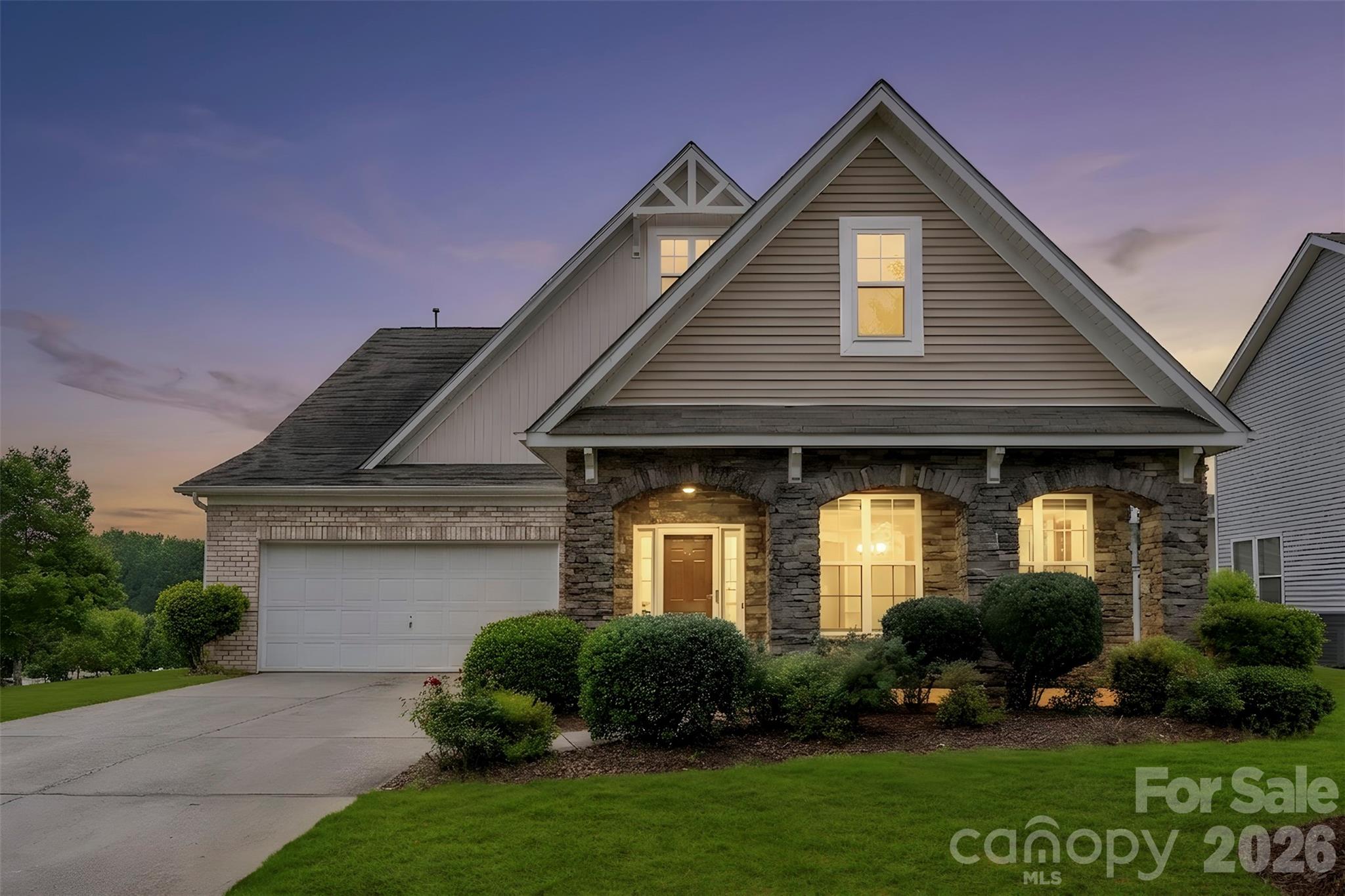 Sitting proudly on a prime corner lot in Skybrook North, this distinctive 1.5-story home stands out with its stone-accented columns and architectural details that give it character long before you step inside. The floor plan is one you don't see every day. Engineered hardwood floors lead into a spacious great room where the gas log fireplace creates a natural gathering spot for everything from quiet evenings to game-day get-togethers. The kitchen was designed for real life, with a large eat-at island, abundant storage, and a refrigerator that conveys, making the move-in process that much easier. One of the home's most practical features is the layout itself. The primary suite is tucked away on the main level, along with a second bedroom that works equally well for guests, a home office, or whatever your lifestyle calls for. Upstairs, you'll find two additional spacious bedrooms, a full bath, and a versatile loft area that can become a playroom, media space, workout area, or second living room. Out back, the covered porch offers a comfortable place to enjoy your morning coffee, unwind after work, or spend time with friends while enjoying the Carolina seasons. With its unique design, flexible living spaces, and sought-after Skybrook North location, this home offers the kind of everyday functionality and character that's hard to find. Faces Northwest.