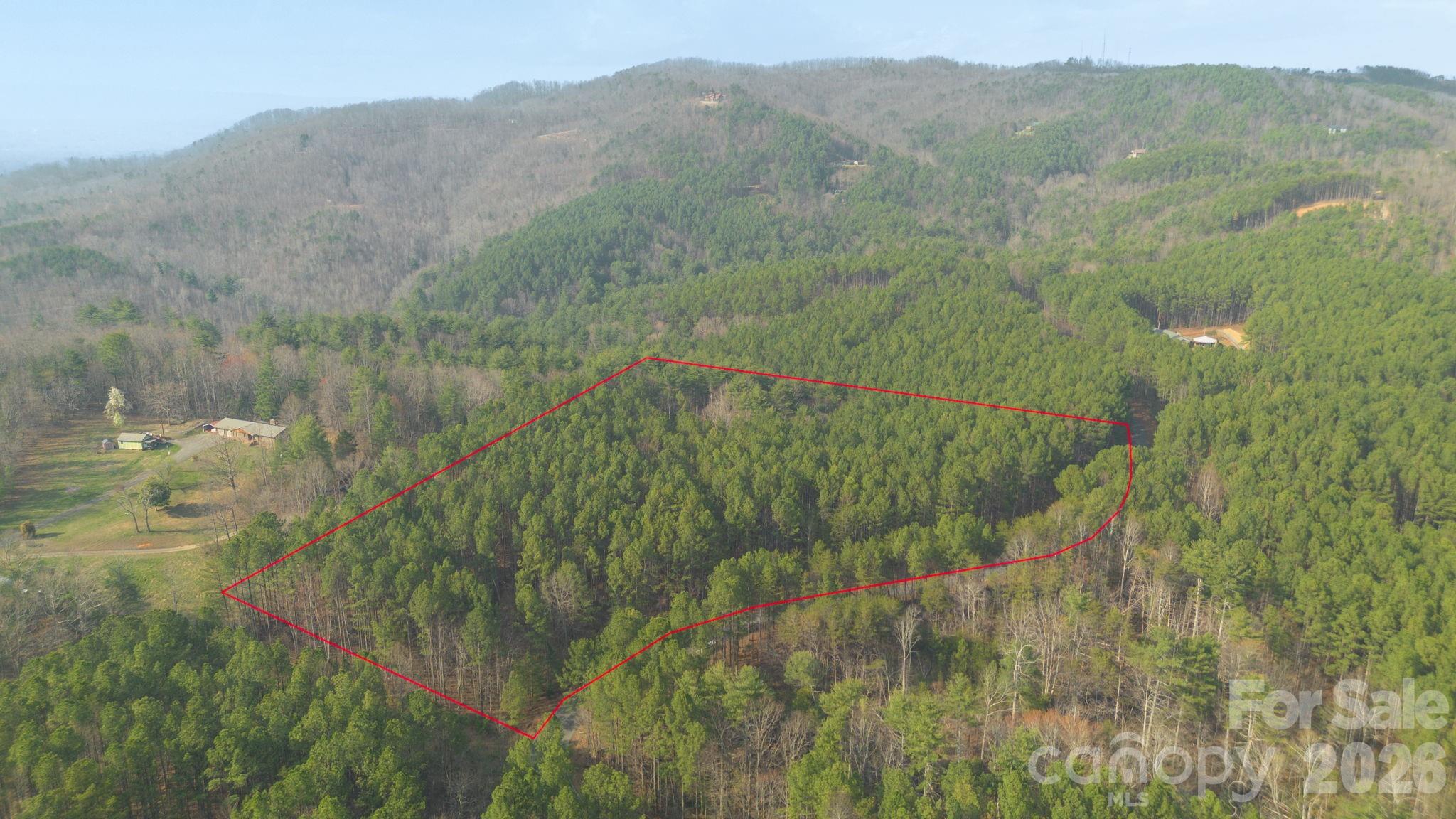 Spectacular lot boasting over 9 acres of gently rolling land on which to build your private residence or vacation home in the mountains of western NC! Nestled atop High Peak Mountain in a gated community with views of the nearby Blue Ridge Mountains, it offers lots of privacy and serenity. Just a short drive up Hwy 18, is plenty of shopping, dining, schools and healthcare. Conveniently located to the interstate, you can enjoy some of Burke counties finest outdoor adventures such as Linville Gorge, Hawksbill Mountain, Lake Rhodhiss, Lake James, Brown Mountain and more. Burke has an abundance of activities for nature lovers from hiking, camping, fishing, boating climbing and many others. No City Taxes and low HOA fees are part of the charm in this tranquil community.