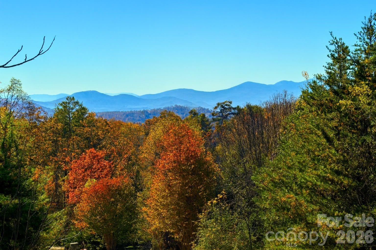Outstanding long range WESTERN SUNSET VIEWS lot in Reems Creek Golf Community, Weaverville, NC! Priced thousands below market value for similar lots in a 2 county area. Financing is also available through United Federal Credit Union with several options. Here's your chance to BUY NOW and BUILD later for a custom home on a premier WNC lot. Have these views for Fall 2026 off your new deck. Located in the highly sought after Hawtree Court area of Reems Creek Golf Community which provides amazing, long-range, Western sunsets.  Large 1.4-acre lot with a great build site. City water & Sewer are ready to tap. No need for drilling a well or installing a septic system. HOA fee only is only $120 annually! City-maintained paved roads with high-speed internet available. Telecommute from your home office, while enjoying the peace and serenity of the exclusive Reems Creek Golf Community. Love Golf? Play the highly rated Scottish Highland Course. The clubhouse was recently remodeled with new pickleball courts, and the outdoor community pool is great for a cool dip in the Summer. The social and golf club memberships are optional and have very active monthly events. Located just 10 minutes from historical downtown Weaverville and 20 minutes to Asheville. Come build your Western NC retreat, as lots like this are at the TOP of the buyer requests list. All neighborhood homes are well-manicured, in a premier location, with great amenities. The lot is priced well below market value for a luxury community. Ready to clear and consult with your local builder. A new home, recently completed, to the left of this lot gives you an example of how much you can clear to build. Book your showing today and come preview this amazing prime builders' lot, in the highly desirable and beautiful Weaverville NC community! Use Google Maps street view to see the new home 2 lots over. We look forward to hearing from you!