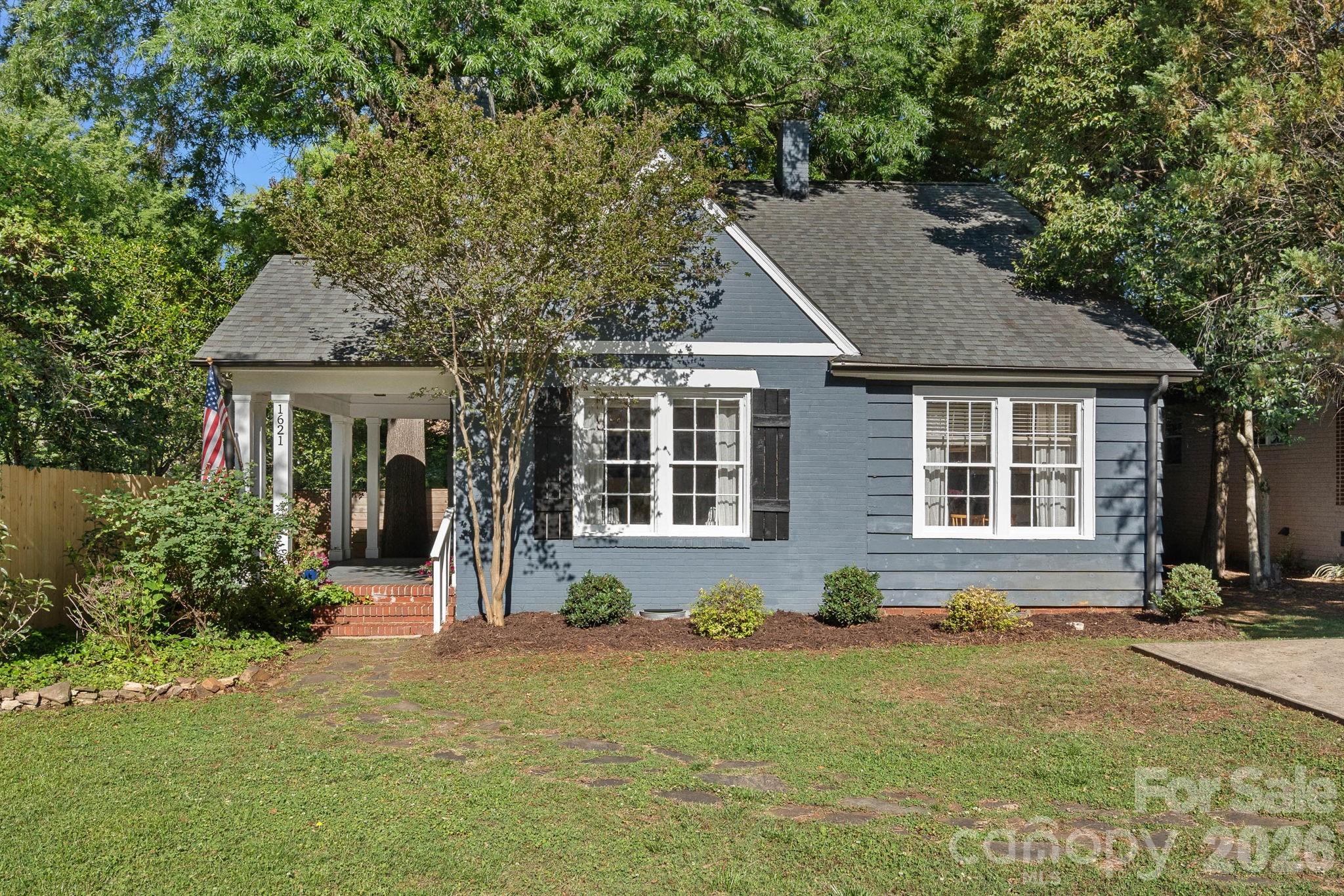 Charming cottage in Plaza Midwood, minutes from some of the city’s best restaurants, coffee shops, breweries, parks, and shops. This home blends original character with everyday livability. The main level features a spacious living room with fireplace, a dining area connected through a classic archway, and a kitchen with white shaker cabinetry, granite countertops, and stainless steel appliances. Flexible floor plan with a main-level bedroom, full bath with marble, and laundry/flex space that works well as a home office. Upstairs, you’ll find two additional bedrooms - including one with original built-ins - and a full bathroom. The deep backyard includes a patio, fire pit, and detached storage building featuring a covered porch, offering additional space to relax or entertain. Walking distance to the proposed Morningside Gold Line stop. Truly incredible value in one of Charlotte’s most popular neighborhoods!