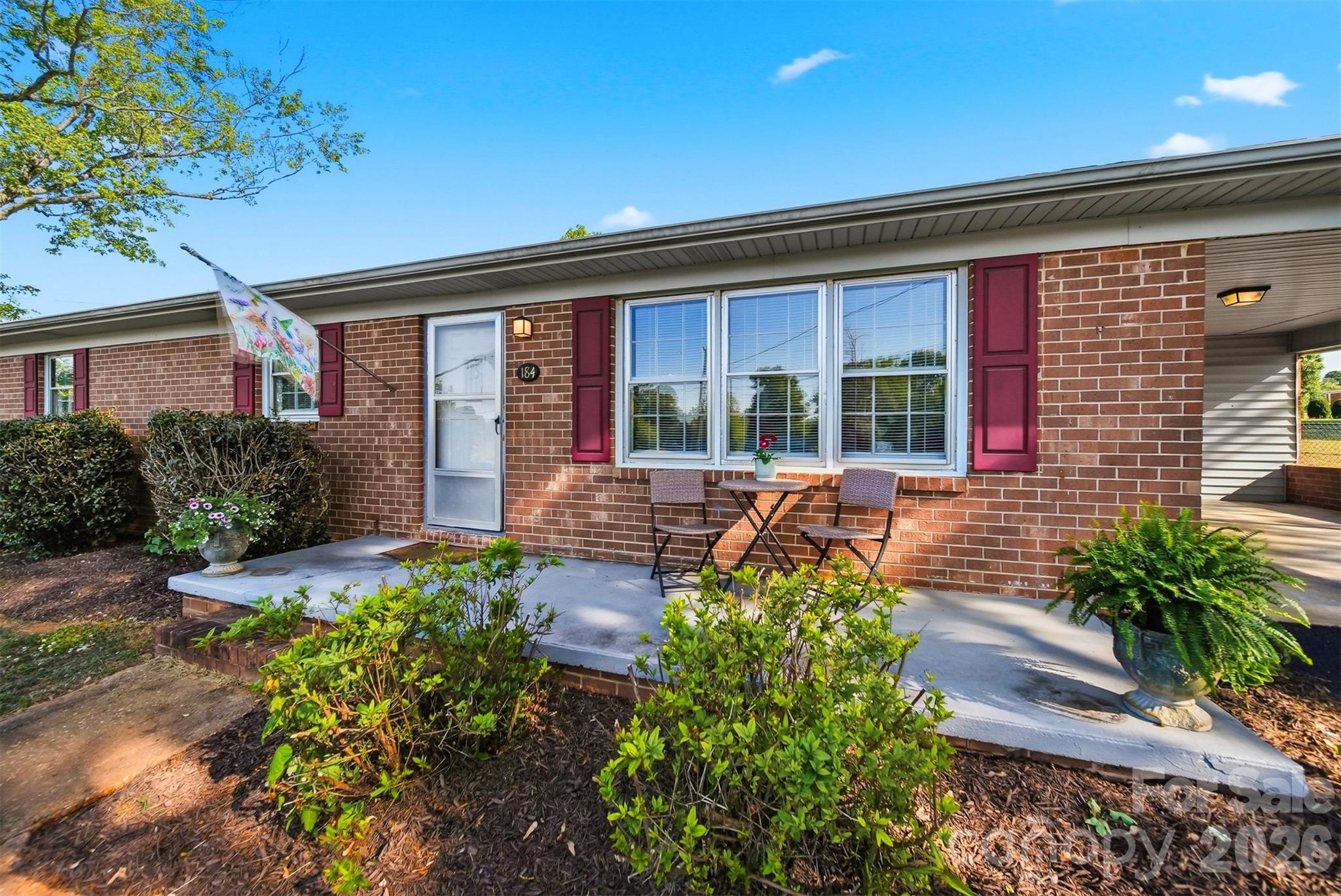 Welcome to this wonderfully maintained brick 3BR/2BA ranch, perfectly situated in a serene, quiet country setting while still offering an easy drive to Hickory and convenient access to shopping and dining in Taylorsville. This inviting one-level home features minimal entry with just a single step inside, making everyday living effortless. Relax on the charming rocking chair front porch before stepping into a spacious living room filled with warmth and comfort. The kitchen has been thoughtfully updated with newer appliances and offers bar seating—perfect for casual meals or gathering with friends and family. The home is equipped with a heat pump installed in 2021 for added efficiency and peace of mind. A cozy wood-burning stove adds character and an extra touch of comfort during cooler months. Step outside to enjoy the large, level backyard—ideal for entertaining, gardening, or simply unwinding. The patio provides a great space for grilling and relaxing, while the newly added 60x90 fenced area offers versatility for pets or outdoor activities. Two spacious outbuildings provide excellent storage or workshop options. This well-cared-for home blends comfort, functionality, and a peaceful setting—don’t miss your opportunity to make it yours! This property is within 1/2 mile of a voluntary agriculture district.