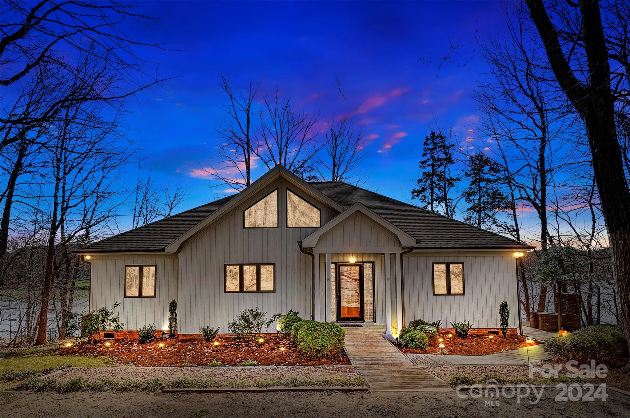 Enjoy stunning lake views from this beautiful single-level waterfront home.  Located on a gentle sloping lot with approximately 260 ft. of shoreline along the Mill Creek section of Lake Wylie- ideal for swimming, fishing, and boating! Live outdoors on the fabulous screen porch, multiple spacious decks, or covered dock w/ boat lift and sun deck!  All are perfect spots for outdoor entertaining or just to relax and take in the views. Indoors you'll find an easy living open floor plan, hardwood floors, beautiful moldings, spruce vaulted ceiling, and amazing views of the lake. This waterfront treasure also features a spacious kitchen with plentiful cabinetry and counter space, center island, immense dining area, and light filled great room with spectacular stone fireplace! The on-shore boat house & storage building are perfect for storing all your lake toys.  Excellent Clover schools, SC taxes, convenient to shopping and dinning.