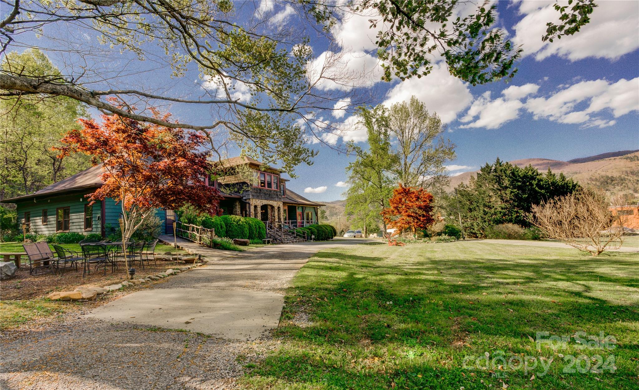 Located in the mountain and river town of Hot Springs. Historic arts and crafts mountain lodge and venue on 7+
acres adjoining the Appalachian Trail and National Forest. Renovated and Spacious open living and gathering rooms,
dining and commercial kitchen. 9 BR, 8 BA well appointed suites, 2 HB. in main lodge. Also includes a separate hostel building with 8 private and semi private rooms and 2 dormitory bunk rooms. 3 BA, 1 HB. In addition there is a beautiful multi-purpose use building. Great venue for weddings, events, retreats and workshops. Panoramic
mountain views. Well kept grounds with lots of open land to accommodate gatherings. Room to expand if needed.
Easy direct access, yet private and tucked away, right next to downtown. Amazing property and destination!