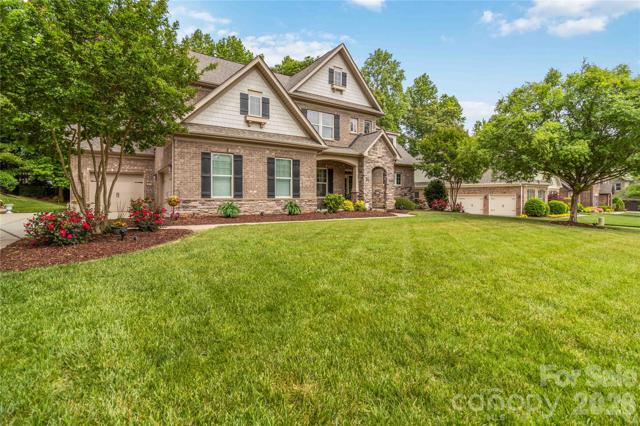 Exceptional full-brick luxury home in the sought-after Barber Rock community! This meticulously maintained residence showcases a main-level primary suite, a grand two-story great room with a striking stone fireplace, and a spacious three-car garage—perfectly blending comfort and refined design.

Enjoy serene outdoor living from the covered front porch or unwind in the private, tree-lined backyard offering added privacy. Thoughtfully appointed upgrades include central vacuum, professional landscape lighting, and full irrigation in both front and rear yards.

Barber Rock offers desirable community amenities, including a clubhouse, outdoor pool, playground, and recreation areas. Ideally located near Fort Mill, Indian Land, and Ballantyne, with convenient access to shopping, dining, and major commuter routes. An exceptional opportunity to own a luxury home in a prime location. Schedule your private tour today!
