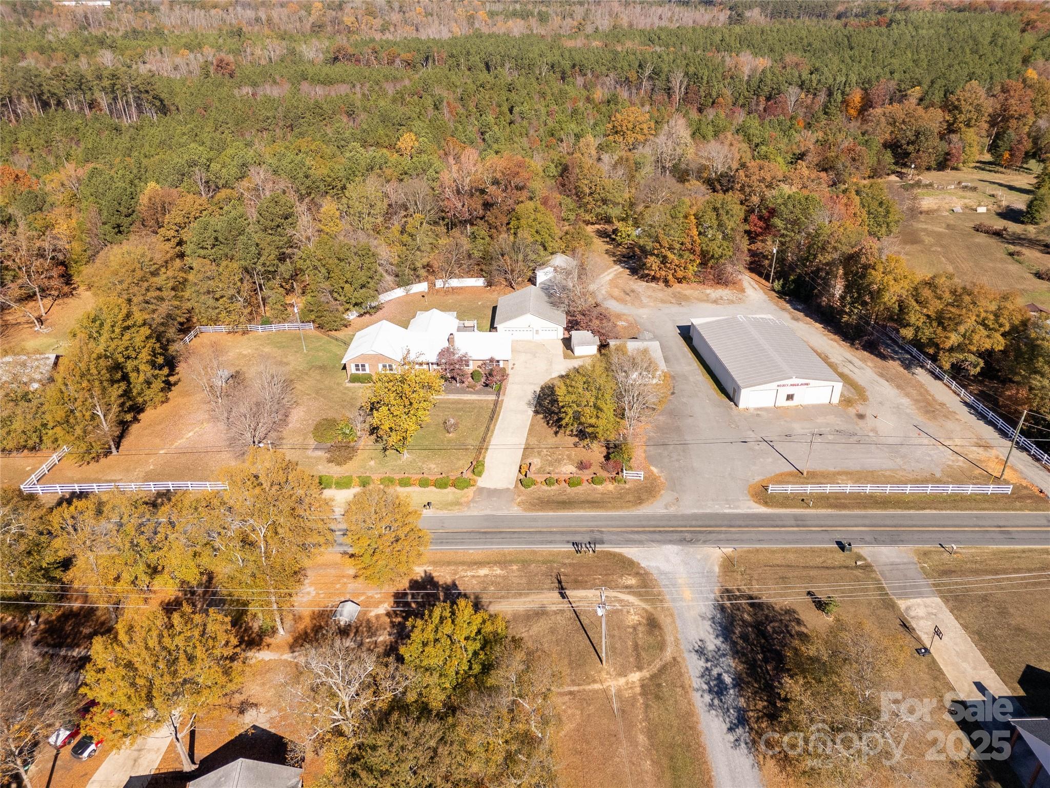 Discover a truly one-of-a-kind property tucked away on 4.25 gorgeous acres in Catawba, SC—offering privacy, space, and endless possibilities. This beautifully updated 3-bed, 2-bath home blends modern comfort with inviting character. Step inside to LVP flooring, granite countertops, and refreshed cabinetry that give the kitchen a bright, clean feel. A sunken living room with a wood-burning fireplace sets the tone for cozy evenings, while a separate oversized den with a propane log insert offers the perfect second gathering space for movie nights or game days. The large primary suite features dual closets and a dual-vanity layout, providing the comfort and storage homeowners need. Outside, a sprawling back deck overlooks a mix of manicured landscaping, open yard, and peaceful wooded privacy—ideal for relaxing, entertaining, or simply hearing nothing but nature. But the true rarity lies in the incredible outbuildings. A 2-car attached garage is just the beginning. A separate 3+ car detached garage with workshop space, tractor shed, and two additional storage buildings create room for tools, equipment, or collections. The 928-sq-ft heated/cooled building with a bathroom—previously used as an office—opens the door for endless uses: a studio, guest retreat, hobby space, or personal escape. And then there’s the showstopper: a massive 50' x 75' metal warehouse with 11-ft walls and additional 548sf rear storage. Whether you're a car enthusiast, collector, craftsman, or someone who simply needs serious space for passions and projects, this structure is a rare find that elevates the entire property. Quiet country living, unmatched storage, and room to dream—this Catawba retreat is ready to welcome its next owner.