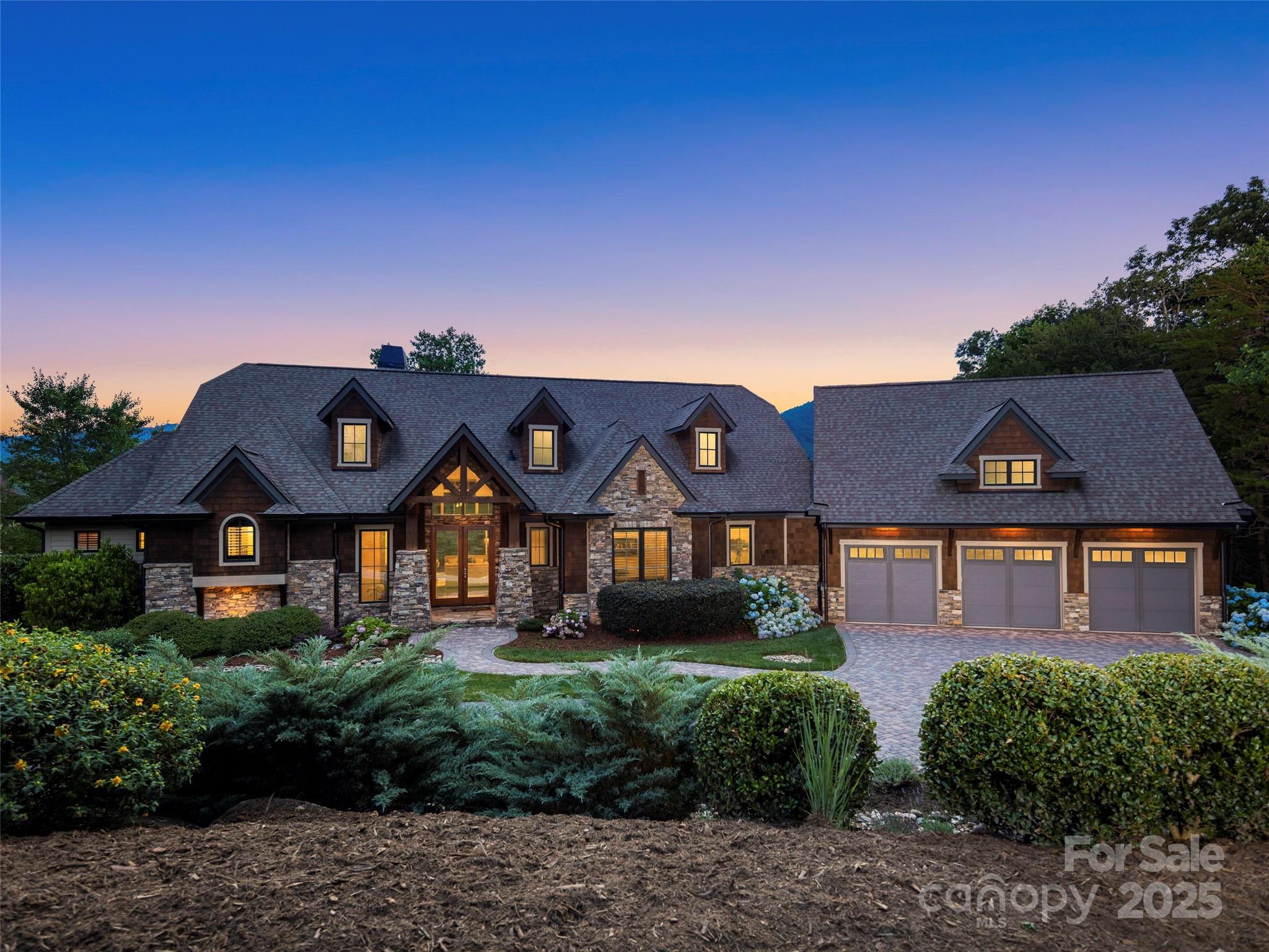 Modern design, convenience, and sunsets await in this outstanding mountain home located directly on the 11th green at The Cliffs at Walnut Cove's Jack Nicklaus Signature "Amen Corner". The large private lot is situated next to Pisgah National Forest protected land, so you are assured ongoing peace and quiet. Only steps to the Walnut Cove clubhouse, tavern and golf, yet it feels like a world away. Inside discover polished finishes and neutral décor with Brazilian Cherry floors. The easy one-level living includes an inviting great room, spacious screen porch with grill and electronic blinds, walk-in pantry, heated and cooled 3-car attached garage, an elegant primary suite, home elevator, and fabulous storage. The terrace level has another guest suites and a family/billiard room with its own entertainment kitchenette and screen porch plus outdoor terrace. A new home elevator and new Generac generator complete the package. Turnkey - All you need to do is move in!