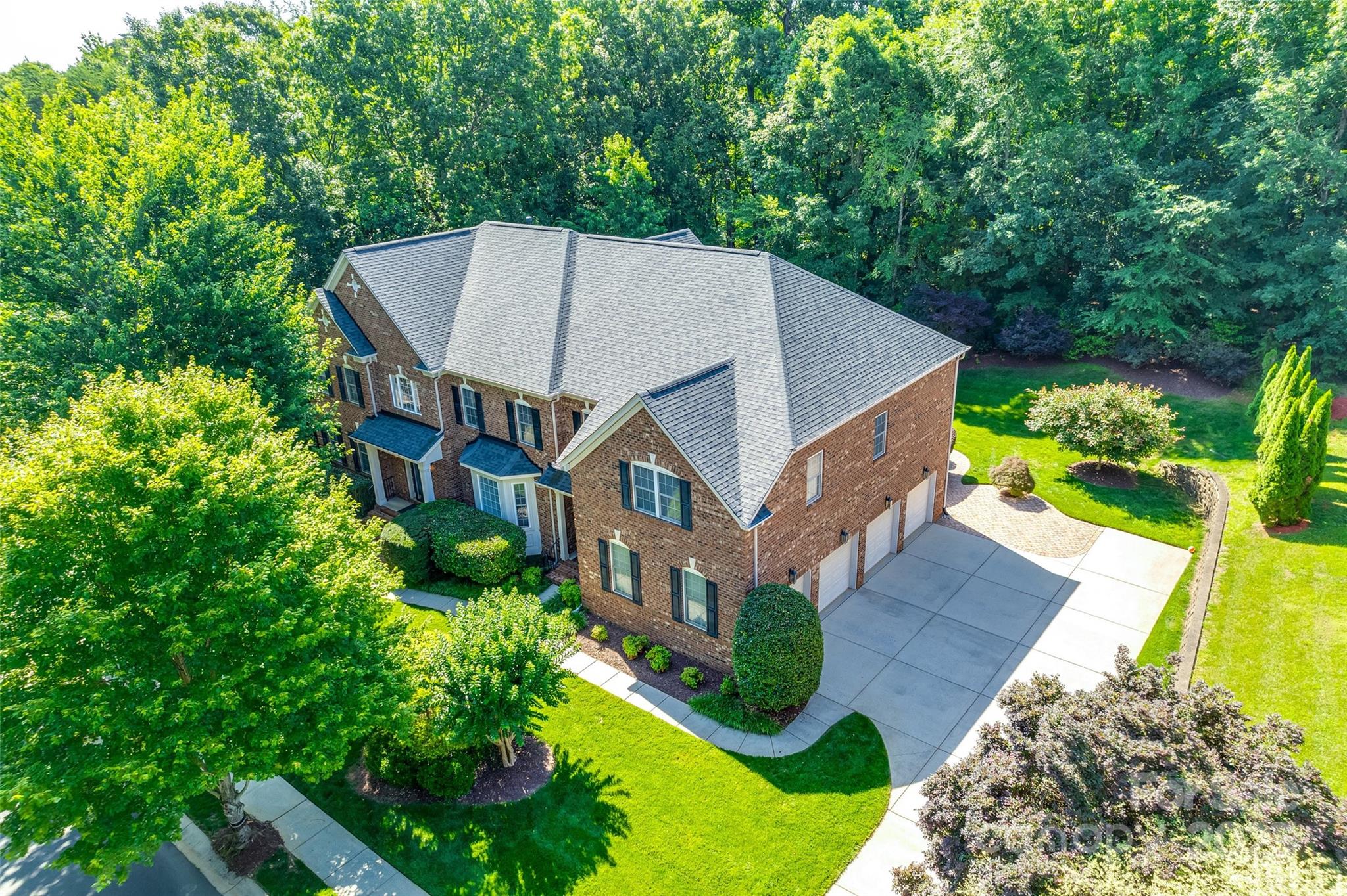 Tucked away in a prestigious Weddington enclave, this residence offers timeless elegance and unrivaled convenience—just minutes from Waverly, Ballantyne, and I-485. Chef’s kitchen anchors the home w/ large island, gas cooktop & double ovens, granite counters, large pantry & an elegant butler’s pantry—ideal for entertaining. 2-story great room is a showpiece, complete with a beautiful stone fireplace & motorized blinds. Private study w/ French doors, perfect for remote work. Expansive primary suite features a lovely chandelier, spacious sitting area, spa bath & 4 closets (2 walk-ins + 2 more closets)! Thoughtful design w/ 2 bedrooms sharing a Jack & Jill bath while 2 bedrooms each offer private bathrooms. Substantial moldings are found throughout.  Nicely landscaped, full irrigation & Trex deck complete the outdoor living. 4-car garage equipped with EV charging station is perfect for car enthusiasts or collectors! Top-ranked schools. Come discover refined suburban living at its best!