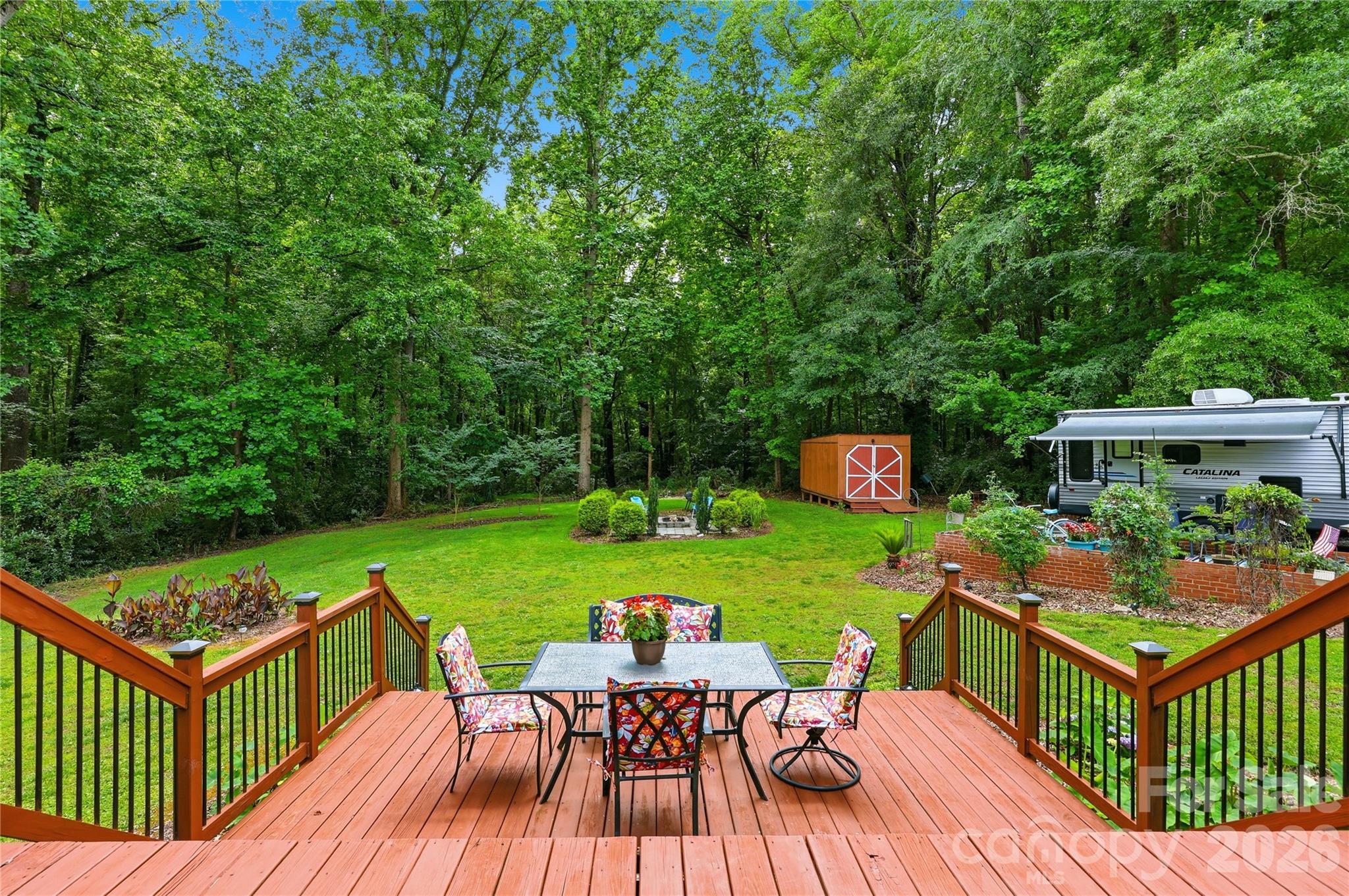 Character • No HOA• Beautiful Lot
 If outdoor living is on your wish list - check out this charming home. With NO HOA, this full-brick 3/2 home blends the character of a cottage home with modern updates. Step outside to what sets this property apart. The private, tree-lined backyard backs onto an undeveloped wooded area, creating a retreat where you can relax and enjoy nature year-round. The large Multi-Tiered Deck is perfect for entertaining. The upper deck was constructed with 6x6's for additional support should you decide to screen or have it enclosed, while the Fire Pit area is ideal for cozy nights under the stars. The Storage Shed remains, and RV owners will appreciate the Dedicated Full RV hookup. Inside, you'll find refinished original wood floors throughout the home, with tile in the kitchen and baths. In the living room, enjoy the stone-surround fireplace with wood mantle, complete with gas logs. You'll love the light-filled, updated kitchen that overlooks the backyard. Quartz counters, Frigidaire stainless appliances, gas cooktop/range, recessed lighting, under-counter lighting, and the Refrigerator stays! The flex room off the kitchen is used as a breakfast nook, but you decide what works best for you - office, playroom, drop zone, etc. The primary bedroom with an ensuite bath has a separate tub and dressing area, shower, and double vanities.  Enjoy the best of both worlds - quiet country living with the convenience of shopping, dining, medical facilities, Fort Mill schools, parks, golf courses, Main Street, Lake Wylie, and major commuter routes close by.