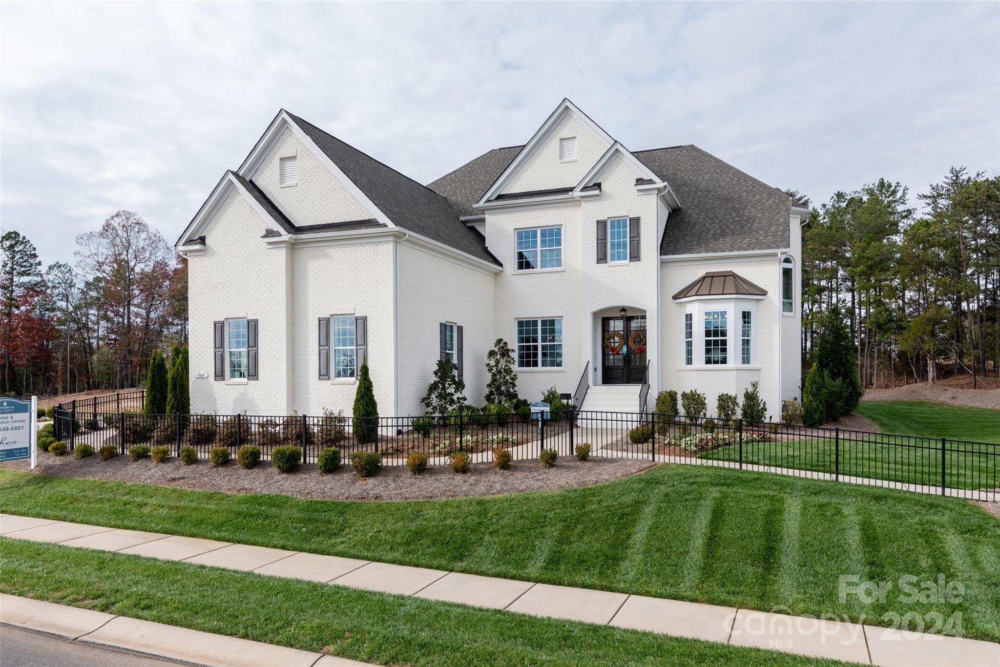 Popular Belaire - decorated model home. Lot backing to mature trees for terrific privacy. 4 sides painted brick exterior. 5 Bedrooms -Premier Suite on upper floor w/ a well-appointed premier bath. Plus a private guest suite on the main level. Open kitchen/family room great for entertaining. Formal living and dining rooms off the two story entry foyer. Mud room off garage with drop zone. Spacious bedrooms up - one with its own bath and a Jack-n-Jill bath for the other two bedrooms. All with great closet space. Convenient laundry room just off the mud room w/ cabinet and quartz counter top and a sink. Creamy white painted kitchen cabinets stacked to the ceiling w/ large center island and gourmet appliances. Terrific bonus room up perfect for media. 3 car side entry garage plus 1 car carriage garage. Covered Rear Deck w/ outdoor gas fireplace. Luxury finishes throughout. Terrific neighborhood