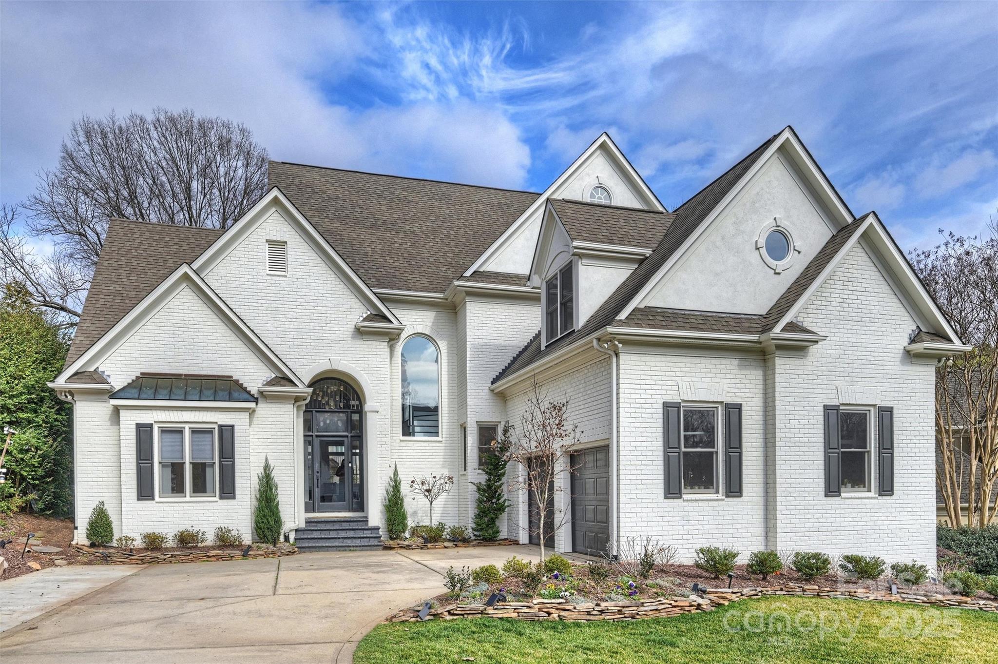 This beautiful Myers Park home showcases high-end finishes and thoughtful updates throughout. Inviting foyer with plenty of natural light though-out the home. Every room has been transformed, from the sleek kitchen with premium appliances and custom cabinetry to the elegant primary baths with new vanities and fixtures. New flooring, doors, and fresh paint enhance every space, inside and out. The exterior features a newly designed front door, smart window shades, and a stunning landscape with a sparkling pool (saltwater/heated), infinity-edge hot tub, and putting green. The backyard also boasts high-end turf, decorative retaining walls, and smart lighting, making it the perfect backyard retreat. Upgrades include a new mudroom with custom storage, smart irrigation, a gas fireplace, and whole-home water filter. The garage offers new flooring, cabinets, and smart doors. Screened porch with outdoor fireplace. New tankless water heater and expanded driveway, no detail has been overlooked.