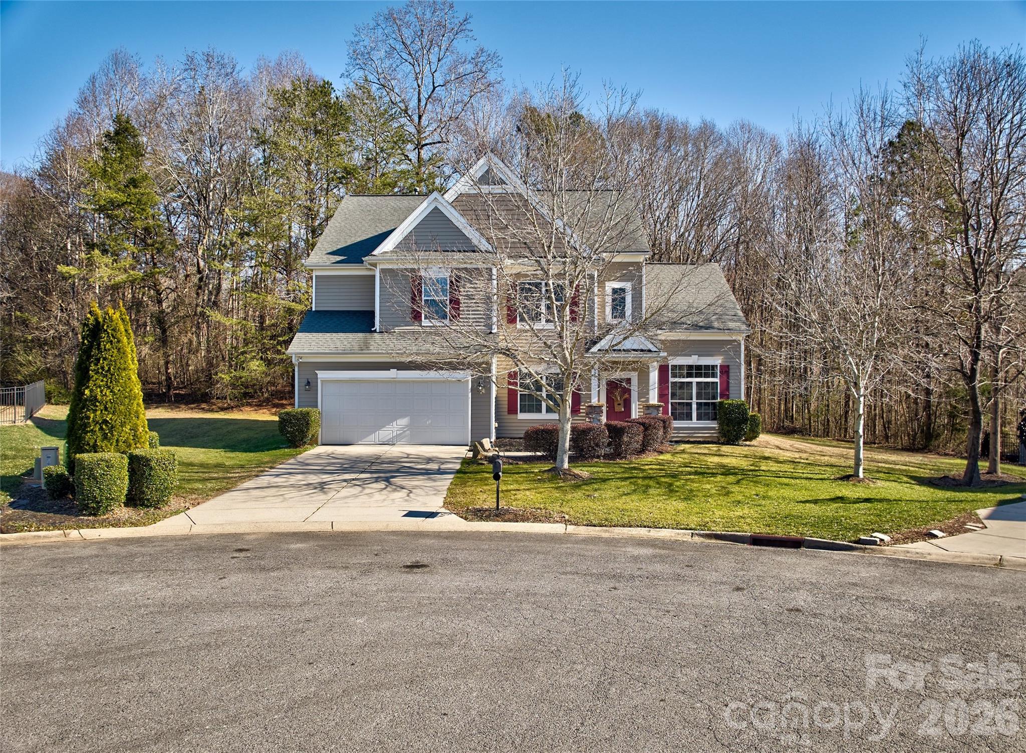 Welcome home to comfort and private backyard that backs up to woods.  Well maintained and cared for home with 1 owner.  4 bedrooms and 3 full baths.  A bedroom and full bath on main floor for all your multigenerational needs! Great room with high ceilings and a bonus room too.  Great flow with the floorplan and open to sunroom, kitchen, dining room and great room. Large primary bedroom and spa like bathroom.   This home has large kitchen with custom cabinetry and huge island.  The sunroom begs you kick back and relax!  Lots of space and outdoor living to enjoy with patios and sitting areas.  The one is located in desirable Mill Creek Falls neighborhood that has walking trails, tennis and pickle ball courts, playground and pool with club house.. It is in the highly rated Clover School District too.   30 minute commute to Charlotte International airport and convenient to commute to Charlotte, Gastonia and Rock Hill. Priced to sell!  Come enjoy all that Lake Wylie and surrounding area offers!!
