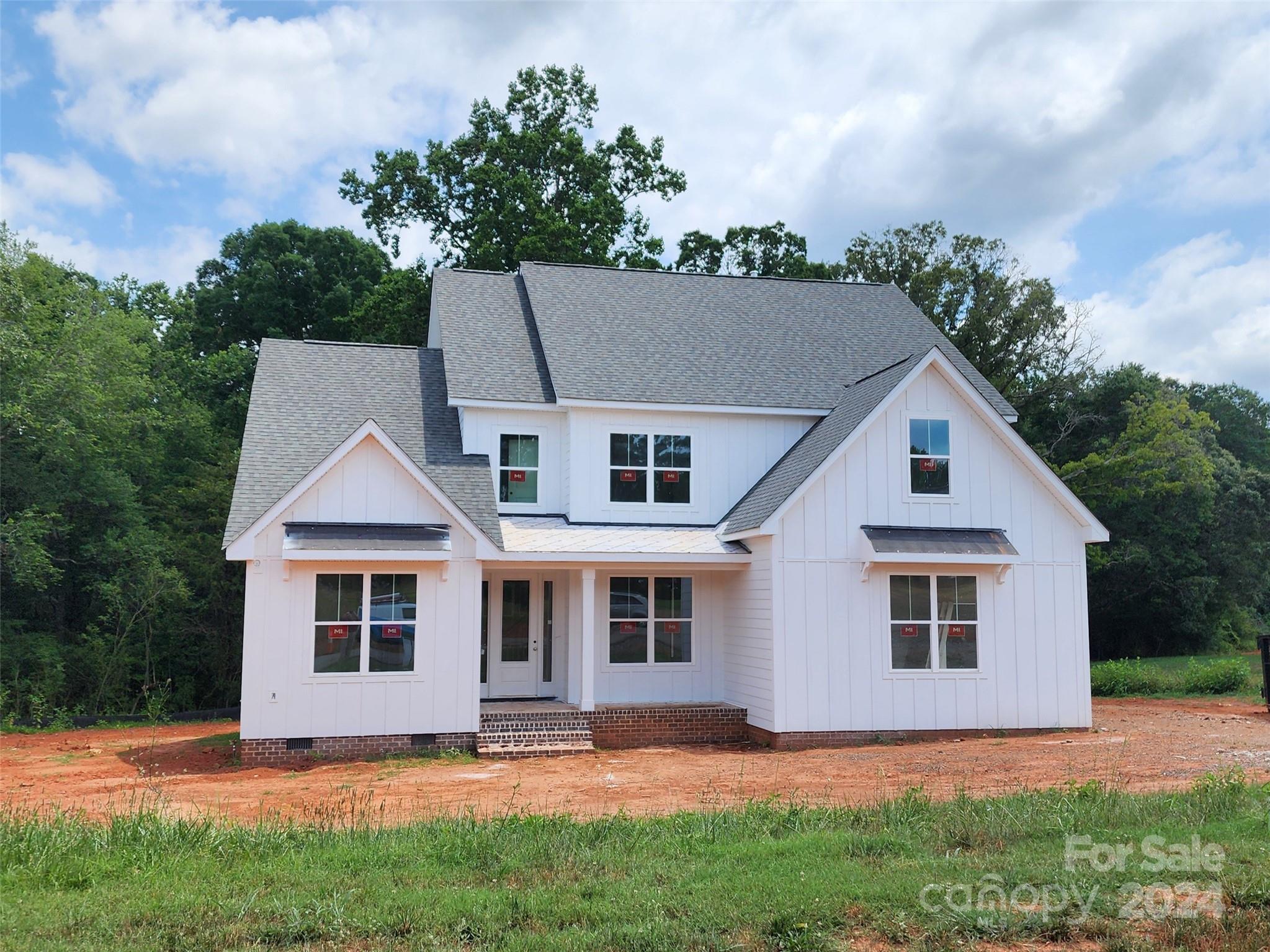 NEW CONSTRUCTION!!! Primary Bedroom Down!!! Over 1 acre!!! 3 car garage!!! You will love all the features in this well appointed NEW home. Stunning White Modern Farmhouse elevation with black metal detail. All the most sought after features like gourmet kitchen with large island, built in ss appliances. Quartz countertops in kitchen and all baths. Wide plank laminate hardwoods throughout the main level and Primary Bedroom. Downstairs Primary Bedroom boasts large bath with tub and tile built shower with seamless glass enclosure and a huge walk-in closet. Upstairs 3 Bedroom, 2 full Baths, Loft and a Bonus Room!! Great entertaining on your back covered deck 12x20 with stone fireplace. Private backyard that backs up to large trees...great combination of open yard and beautiful wooded back drop....over 1 acre!!!!