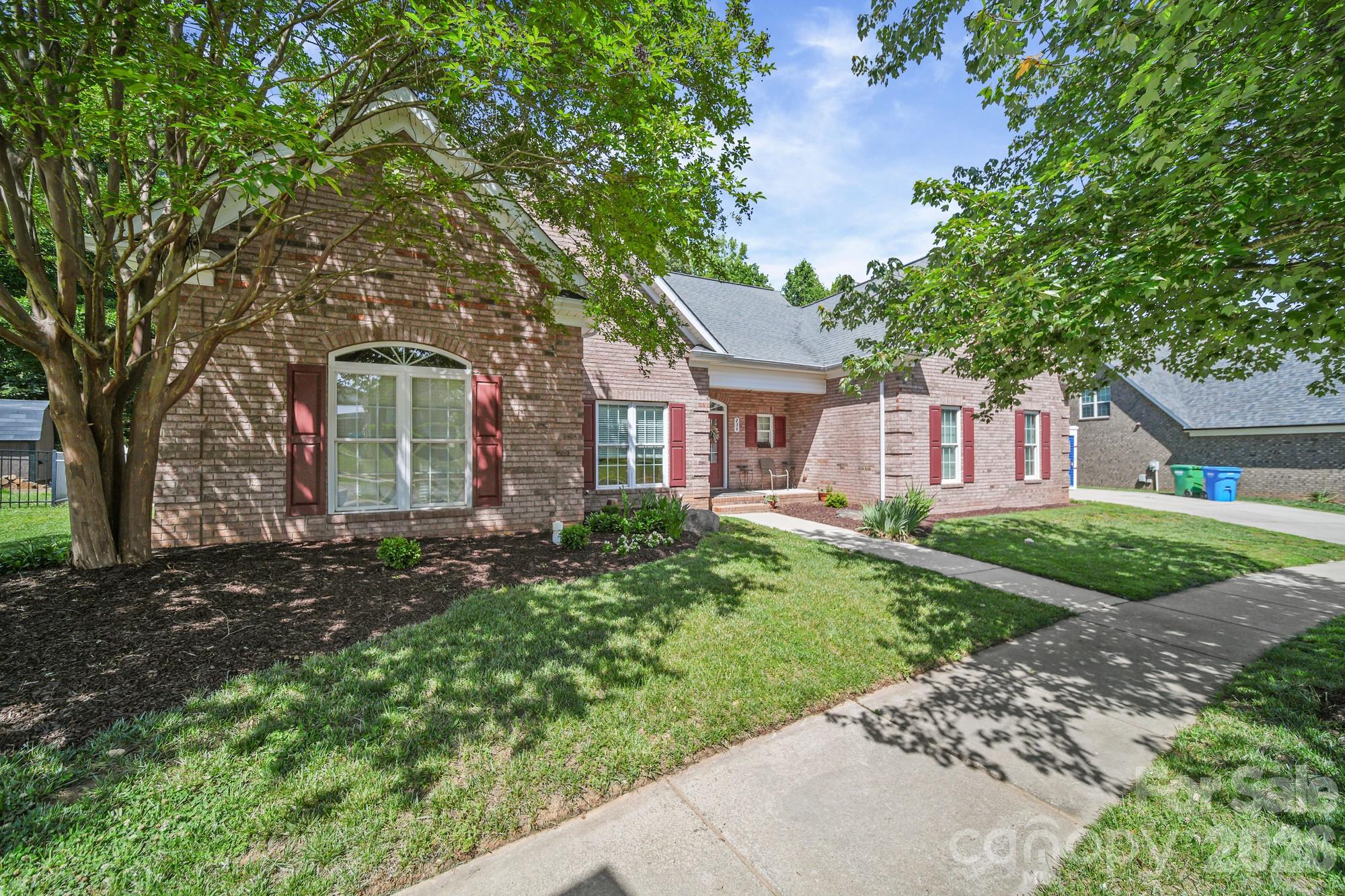 Thoughtfully Updated and Priced to Sell

Tucked away on a quiet back corner of an all brick neighborhood, this beautifully updated home offers the perfect blend of comfort, privacy, and space. Inside you will find custom hardwood cabinetry, granite counters with tile backsplash, and a stunning custom gas-log fireplace with remote control—creating a warm and inviting centerpiece for the downstairs living room. The downstairs windows are strategically placed to bring stunning back yard views year round.

The main level is designed for convenience, featuring a spacious primary suite, an additional bedroom, a dedicated office, laundry room, and two thoughtfully remodeled bathrooms. The primary suite bathroom features a walk in shower and a beautiful stand alone jetted tub. The second updated bathroom has an oversized doorway and a zero threshold walk-in shower for ease and comfort of multigenerational guests.

Upstairs, you'll find a cozy second living area, two additional bedrooms, and an oversized bathroom—ideal for family, guests, or multi-generational living. Brand new carpeting with a transferable lifetime warranty adds fresh comfort throughout. Four storage closets plus pull-down attic access provide an abundance of storage space rarely found in today's homes.

A key feature of this home is the uniquely peaceful and private backyard maintenance-free composite deck that overlooks a serene, wooded area. Mature trees and a completely fenced in back yard make it easy to forget you're even in a neighborhood. Additional features include a complete ADT home security system, a two-car garage with its own separate storage room, and Morris Jenkins priority advantage-maintained HVAC systems.

This spacious home combines thoughtful updates, exceptional storage, and a tranquil setting in one remarkable package. Don't miss your opportunity to make it yours—this is truly a must-see property!