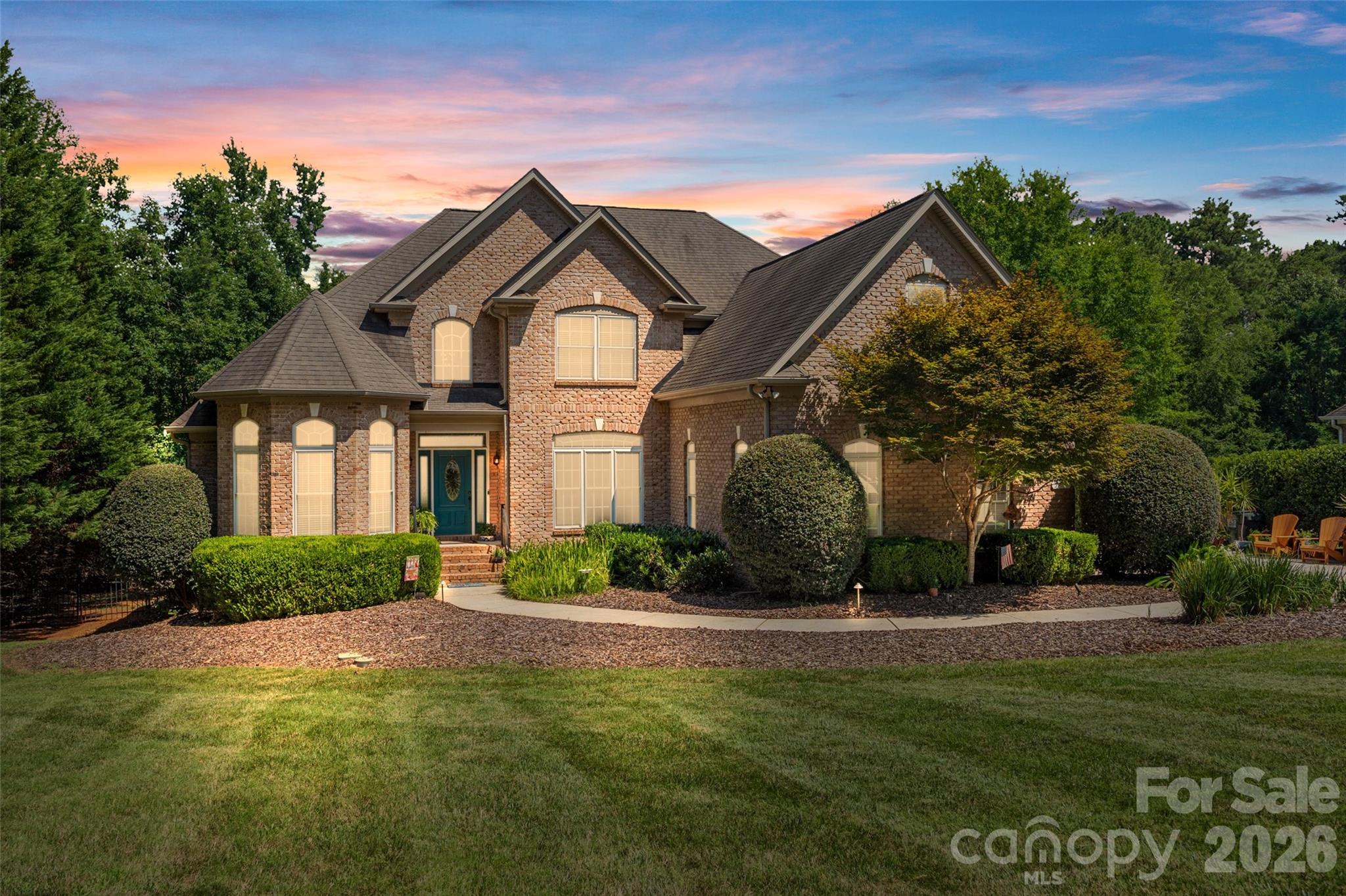 Welcome to this stunning full brick home in the highly desirable Catawba Crest community of Lake Wylie! Situated on over an acre with no HOA or restrictions, this private, wooded homesite offers the perfect blend of nature, space, functionality, and lake community living.

Step inside to a dramatic two-story foyer and great room filled with natural light and beautiful hardwood floors. The thoughtfully designed floor plan features a spacious primary suite on the main level, along with a secondary bedroom and full bath—ideal for guests or multigenerational living. The kitchen is a chef’s dream with gorgeous wood cabinetry, appliance garages, a large gas range, double dishwashers, and abundant storage.

Enjoy year-round outdoor living on the screened-in porch with Trex decking overlooking the flat, fenced backyard and peaceful wooded backdrop. Additional features include a Rinnai tankless water heater, walk in crawlspace, front yard irrigation, solar panels that are fully paid off and wired outdoor lighting. 

Upstairs, you’ll find two additional bedrooms, a full bath, and an expansive bonus/recreation room complete with a mini kitchenette, offering endless possibilities for entertaining, hobbies, or a separate living space.

Car enthusiasts and hobbyists will appreciate the incredible garage space, including a 3-car attached garage and a detached 2-car deep garage with power and storage. Located in the award-winning Clover School District, this exceptional property offers privacy, versatility, and the freedom of no HOA—all just moments from Lake Wylie amenities and Charlotte.