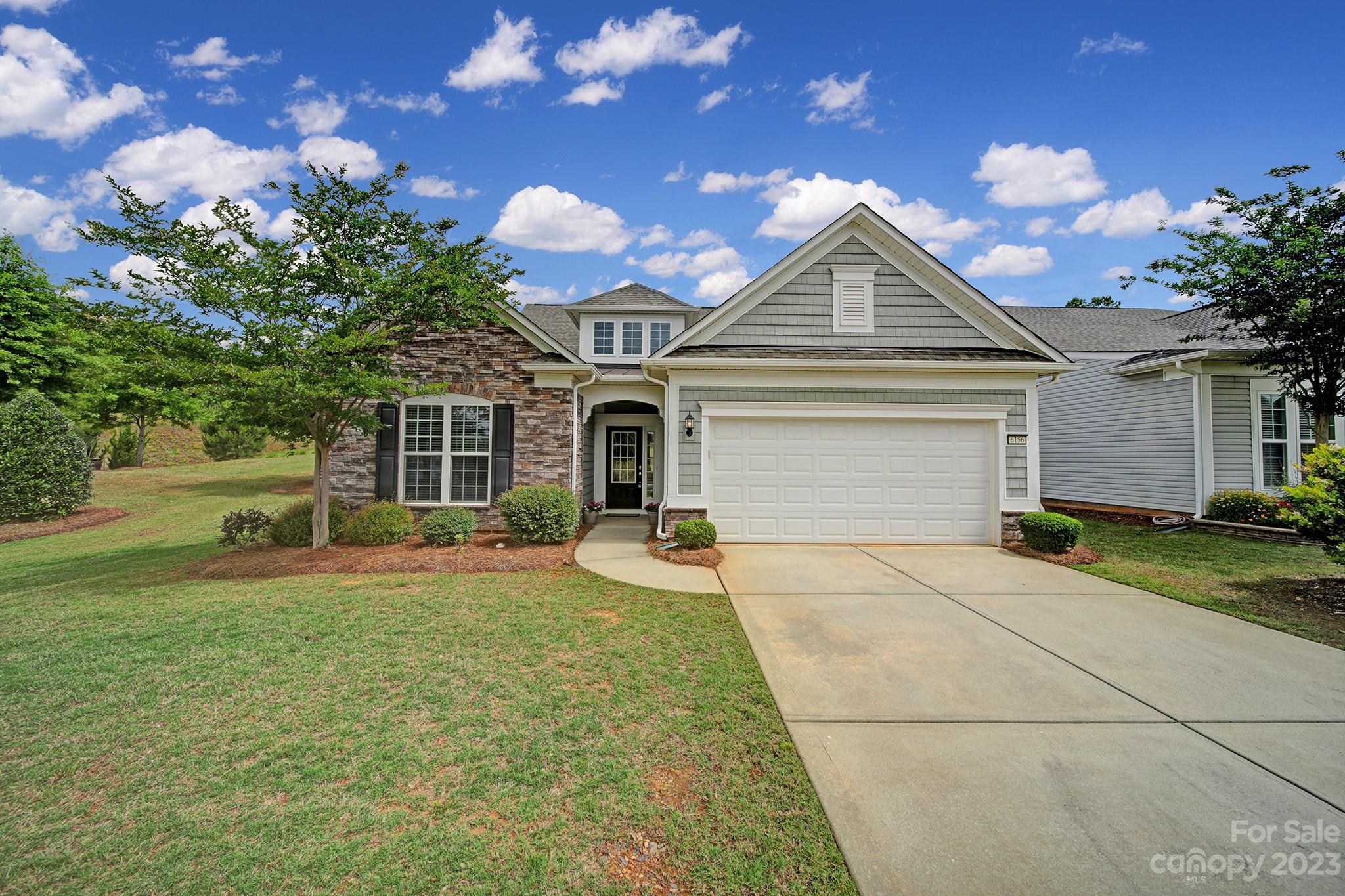 Fantastic opportunity in Sun City Carolina Lake to own a home that is almost BRAND NEW! Only been lived in a handful of weeks since purchase. This 4 bedroom, 3 bath home sits on a beautiful open, yet private & spacious lot! The Vernon Hill plan features stone veneer front & established landscaping. Inside enjoy hardwood flooring & open floor plan w/separate dining area & office, plus a bright & cheery sunroom.  Kitchen features SS appliances, breakfast bar, pendant lighting, white cabinetry, granite counters w/subway tile backsplash & a breakfast nook. Primary suite offers tray ceiling, double vanities, & a custom tile shower. 2 main level guest bedrooms w/plenty of space for visiting company or a flex room. Utilize the upstairs for extra space for crafts, hobbies, or 4th guest suite w/full bath. Lovely back patio overlooks a private & wooded view for a relaxing atmosphere. Come take a tour of all this home has to offer and the amenity rich community of Sun City Carolina Lakes!