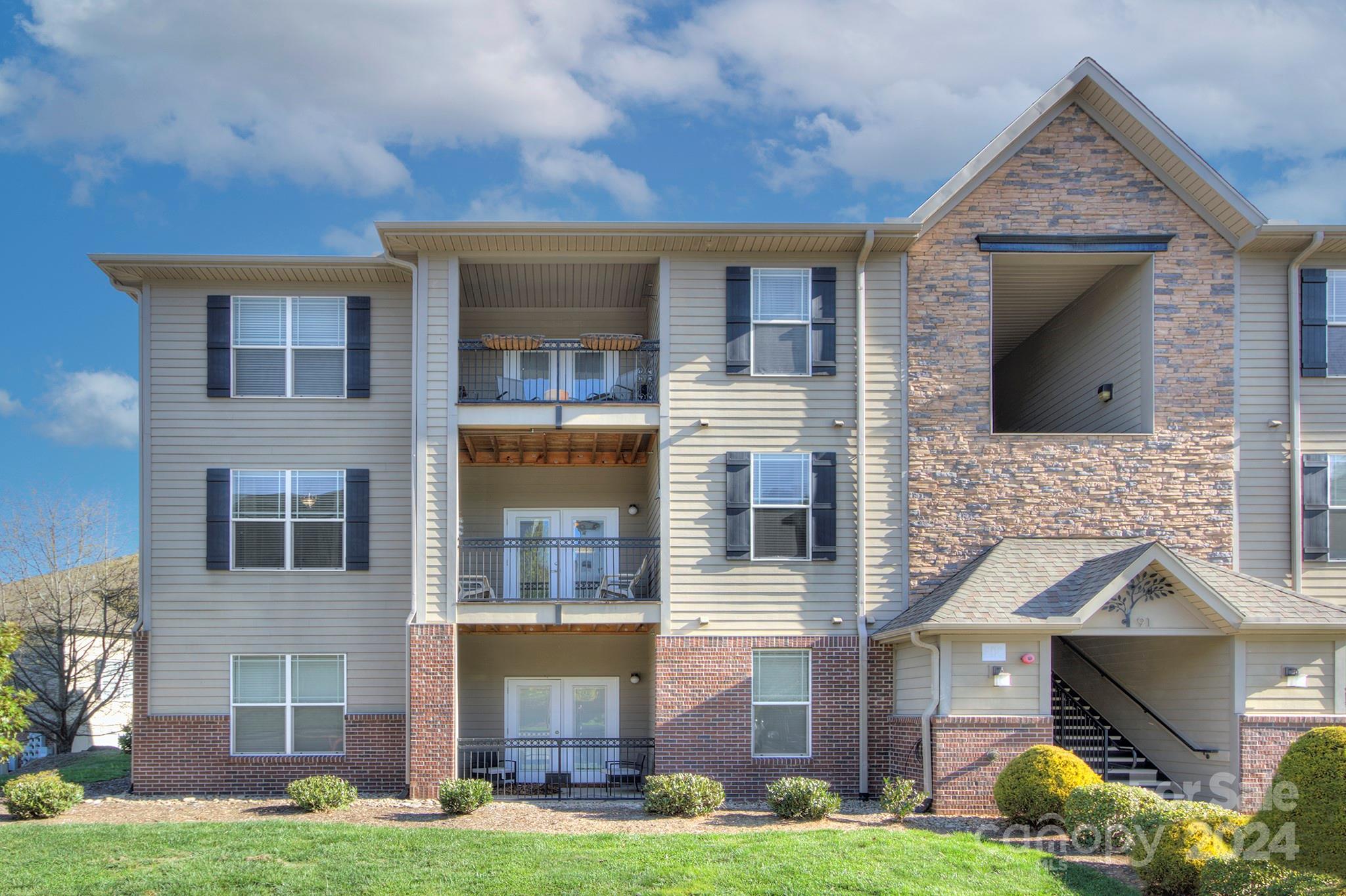 Meticulously cared for and move-in ready, this newer 3-bedroom condo in Brickton Village shows like a model! A corner unit with beautiful natural light and mountain views, this home is located on the 2nd level and accessible by elevator or stairs. The open, split-bedroom floor plan flows to a covered balcony for entertaining. High-end finishes include luxury vinyl plank flooring, stainless appliances, granite kitchen counters and custom barnwood accents in the kitchen. The nine-foot ceilings give the home an airy feel and the luxury window treatments (2" blinds, draperies and awnings) are included. Combine all this with a very convenient Fletcher location, perfectly situated between Asheville and Hendersonville, and just minutes to the airport and a variety of restaurants and shops. The low monthly dues include water, sewer, trash pickup and great amenities: a dog park, picnic areas, a frisbee golf area, and walking trails. Be sure to check out the video!