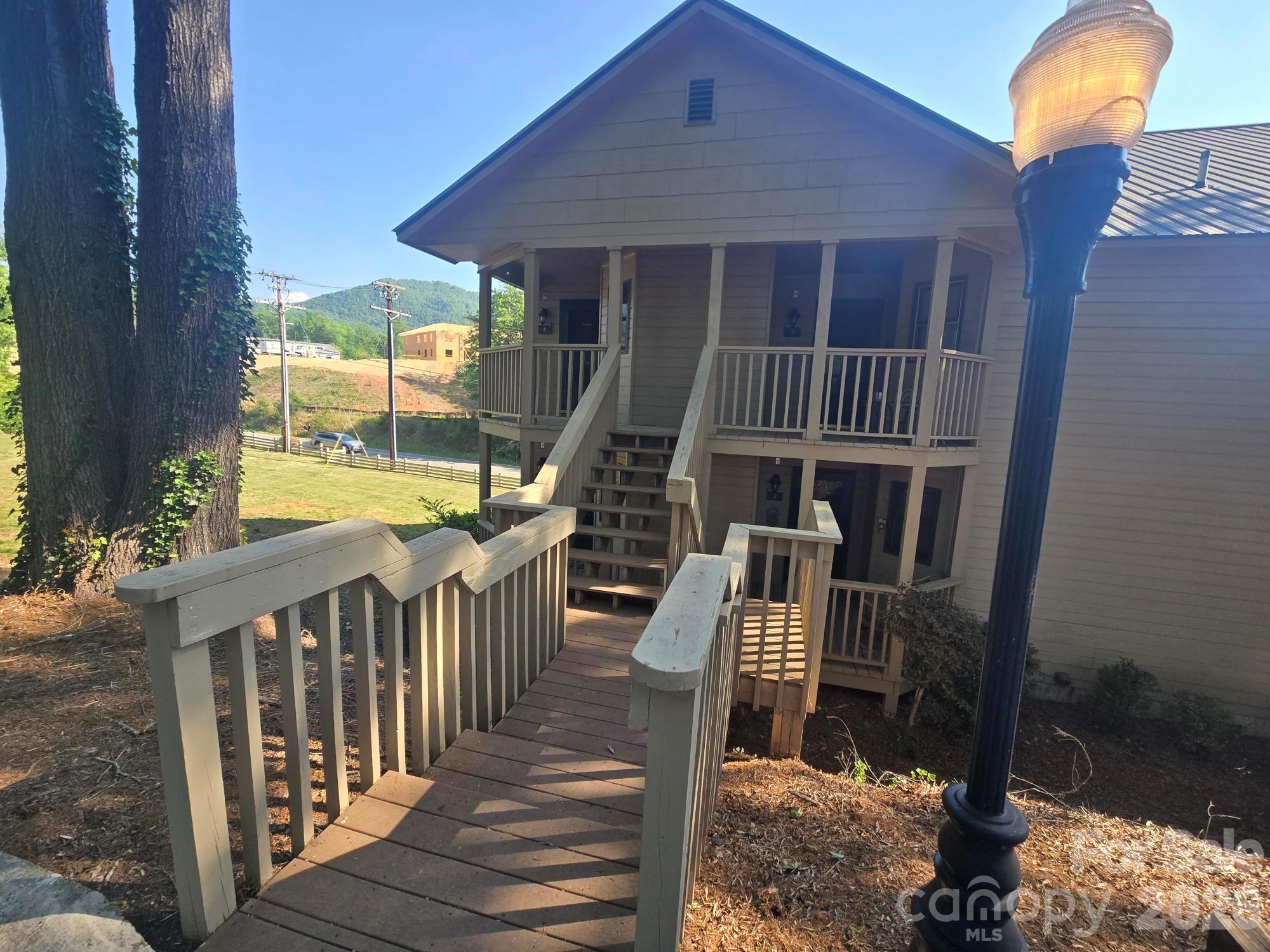 Lovely end unit in Rumbling Bald on Lake Lure. Desirable upper level studio condo that comes fully furnished.  Tastefully updated and staged, this active STR is the perfect getaway and/or investment property. Enjoy your morning coffee on the peaceful covered deck with easy access off the kitchen area.  There is a vanity area next to the full bathroom. All underground utilities with High Speed Fiber Internet available.  The perfect location for living or vacationing while enjoying the many Rumbling Bald amenities including Two Championship Golf Courses, Private Beach, Wellness Center, Water Activities, Hiking Trails, Restaurants, and much, much more!