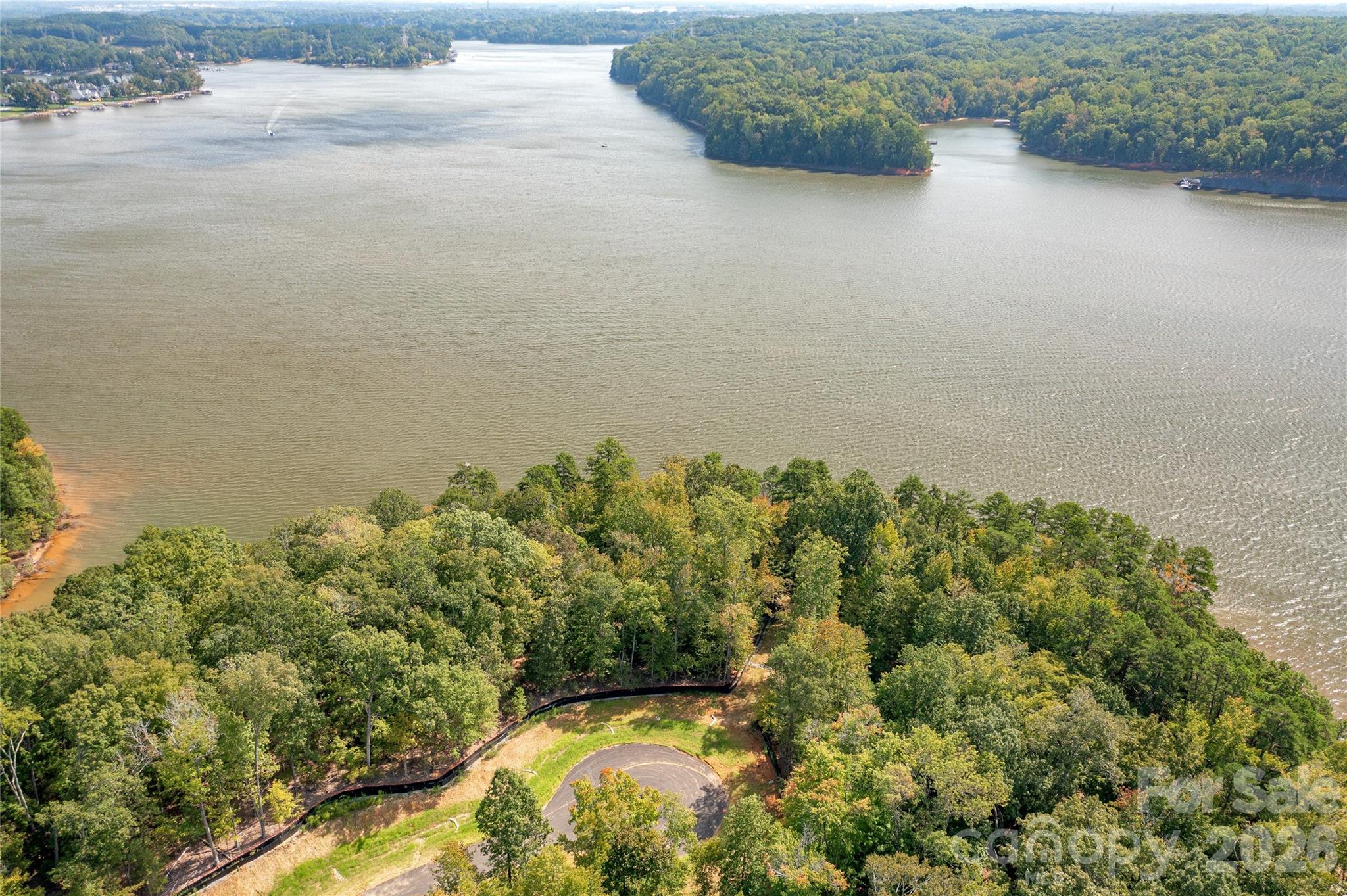 Premier waterfront community on Lake Wylie in Belmont NC. Homesite 28 is in the state of South Carolina on Great Egret and this location is one of the BEST waterfront streets and series of lots that McLean has to offer. The homesite is level and features long and wide southern main channel views, plus you capture the eastern and western sun on the sides. Located at the end a cul-de-sac street, this is an amazing location. Homesite 28 can accommodate a boat dock with your permit from Duke Lake Management at the time you build your home. McLean features exceptional approved builders who can bring your desired home design to life on this beautiful homesite. Once you purchase the homesite, there is no time limit in which you are required to start building a home, so the timing is flexible to your needs! McLean is located in an amazing spot that is quiet, yet so close to so much! Love small town living and casual downtown vibe when you visit the quaint town of Belmont NC - only about a 10-minute drive from McLean. Enjoy Stowe Park in the center of Belmont, or  coffee at Everyday Market, watch the train go by, play/jog/lounge at the park while listening to the fountain on sunny days, or meet friends for dinner at any of the great restaurants in town. Take in all that Uptown Charlotte has to offer in restaurants, theater, sports, and other events - just 30 minutes away. Travel far and wide for work or play - the Charlotte Douglas international airport is only 20 minutes away and you don't even have to get on the highway - YAY! Premier waterfront living is featured at McLean South Shore, the preeminent community within McLean. McLean South Shore offers walking trails, clubhouse, outdoor pool, fitness center, playground. Drift restaurant within walking or golf cart distance. The Carolina Thread trail along Lake Wylie located across New Hope Road. Within minutes of grocery shopping - Publix and Harris Teeter. Uptown Charlotte, South Park and Ballantyne are commutable via nearby highways. Great small town location at the doorstep of a bigger city! Premier waterfront community - Let's walk this homesite today!