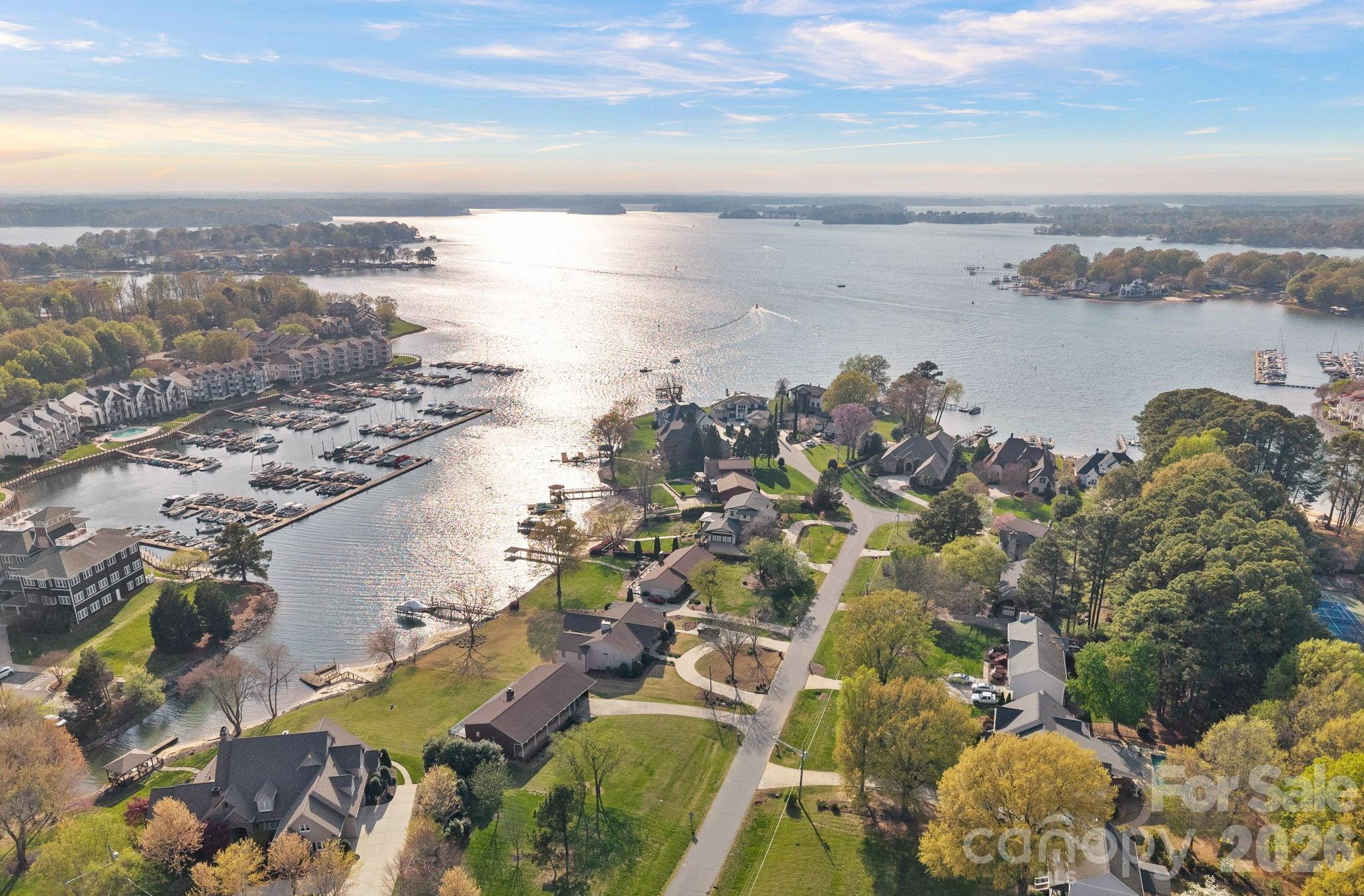 Experience true lakefront living with this rare waterfront opportunity on a .55-acre flat lot with over 110 feet of shoreline, impervious exempt, and no HOA! With its generous shoreline, flat topography, and limitless potential, this is a true Lake Norman gem offering the views, the space, and the lifestyle that make lakefront living so special. Perfectly positioned in a quiet cove off Lake Norman’s main channel, this property offers long-range water views and breathtaking seasonal sunsets that create a peaceful setting. The expansive lot provides both space and privacy, an increasingly rare find, while offering the freedom to build or renovate without restrictions. Whether you choose to enhance the existing home (additional 1,000 ft of unheated basement square footage), or design the custom lakefront retreat you’ve always envisioned, this waterfront property gives you complete flexibility. Surrounded by prestigious multi-million-dollar lake homes, the location blends luxury, tranquility, and natural beauty. The home offers a private dock, ideal for boating, paddleboarding, fishing, or simply relaxing by the water’s edge as the sun sets over the main channel. Conveniently located just minutes from grocery stores, shopping, restaurants, Birkdale Village, parks, walking trails, and major roadways for easy commuting, this property delivers the perfect balance of everyday convenience and elevated lake living. Easily connect to city sewer & city water.