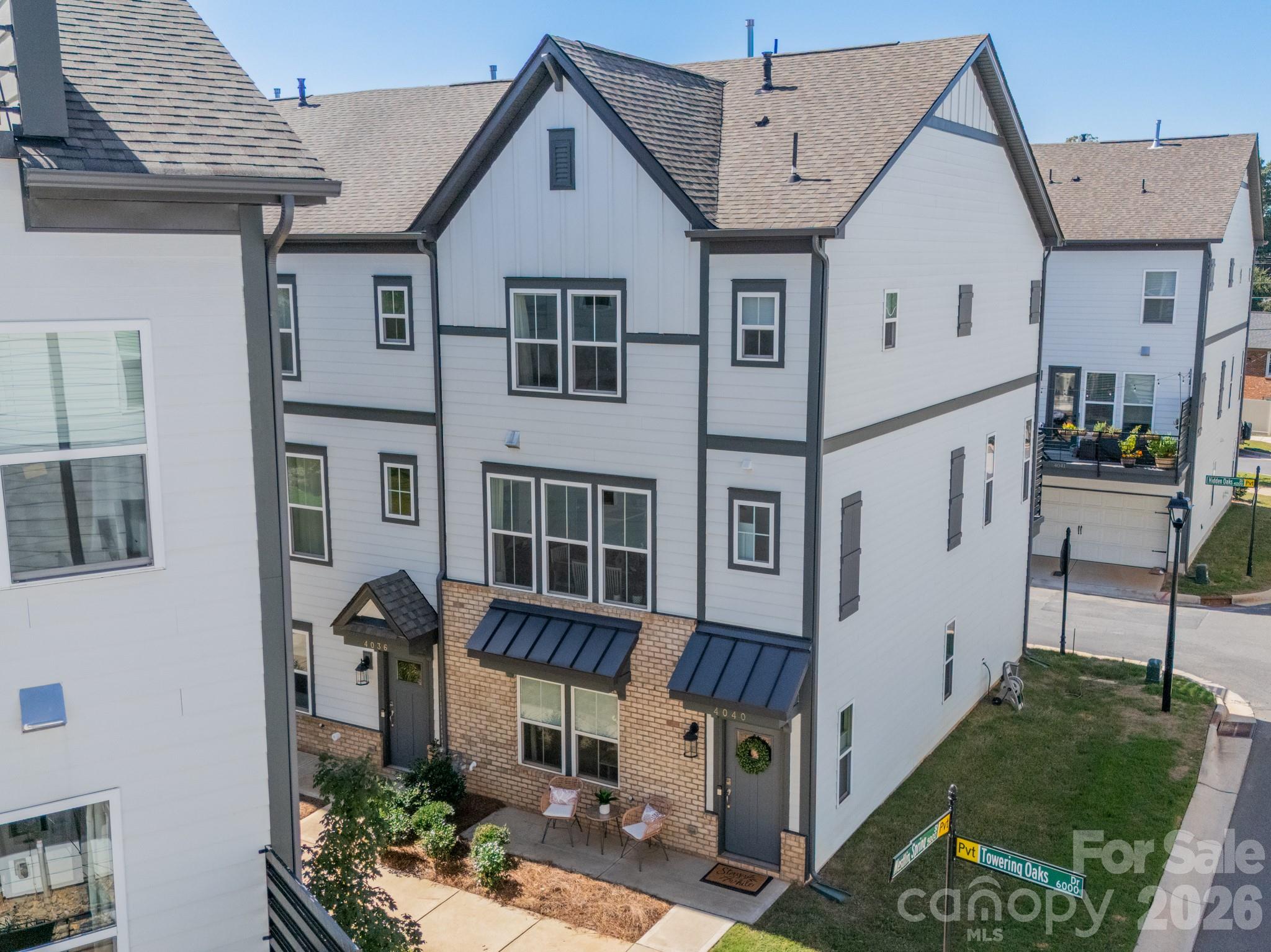 Preferred lender offering a credit up to $5800 towards closings costs or rate buydown! Sleek, sophisticated, and flooded with light, this better-than-new four-story townhome sits just minutes from Charlotte’s best dining, shopping, and nightlife! 

The entry level features a two-car garage with EV charger and a private guest suite with a full bath. The main living level stuns with an open-concept layout, gourmet kitchen with oversized island, fireplace, and deck made for entertaining. Upstairs, find three bedrooms, including a serene owner’s suite with a walk-in closet and a dedicated laundry room. 

The showstopper—a rooftop sky terrace for outdoor dining, morning coffee, or evening relaxation—complete with a bonus storage room that takes this home from impressive to unforgettable!
