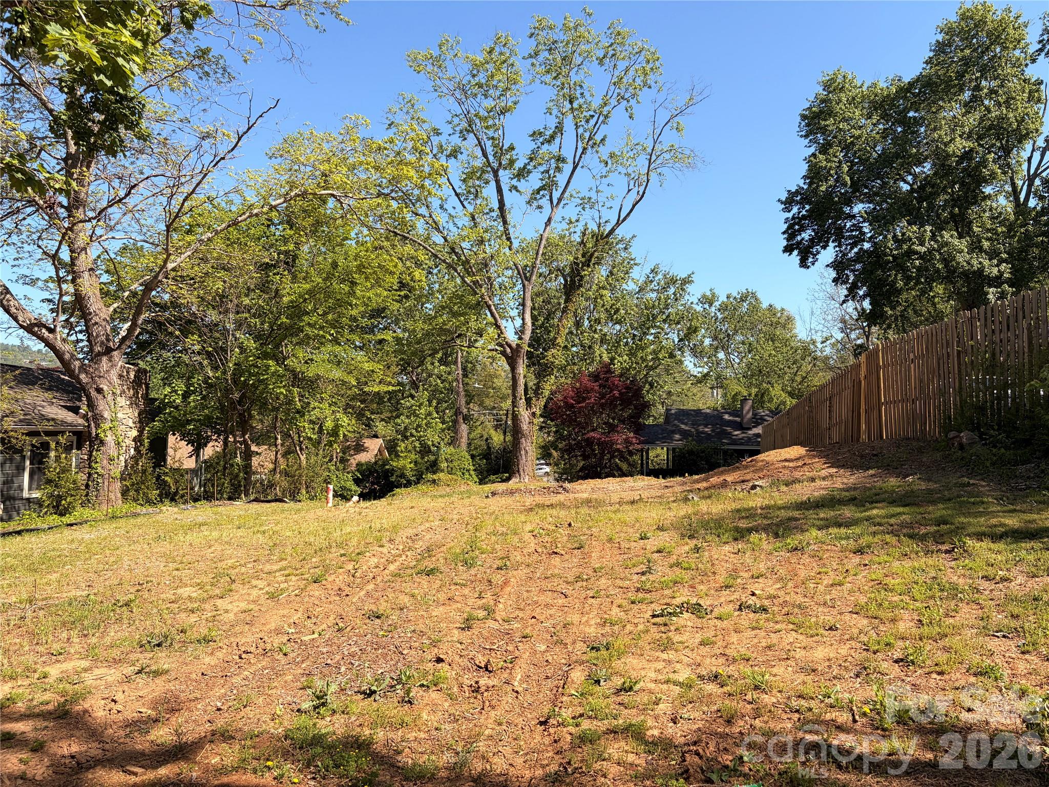 Rare opportunity to build your dream home on a level, cleared lot in one of North Asheville's most sought-after
neighborhoods. This 0.15-acre parcel on Irving Street is fully ready for construction — sewer, water, and gas taps are already on site, saving you time and money before you break ground. A separate access easement off Oaklawn Drive provides convenient access as an alternative to the existing driveway off of Irving Street. Enjoy mature trees, ridge views to the North, and the quiet charm of an established street, all just minutes from the restaurants, shops, and amenities that make North Asheville one of  the area's most desirable places to live.