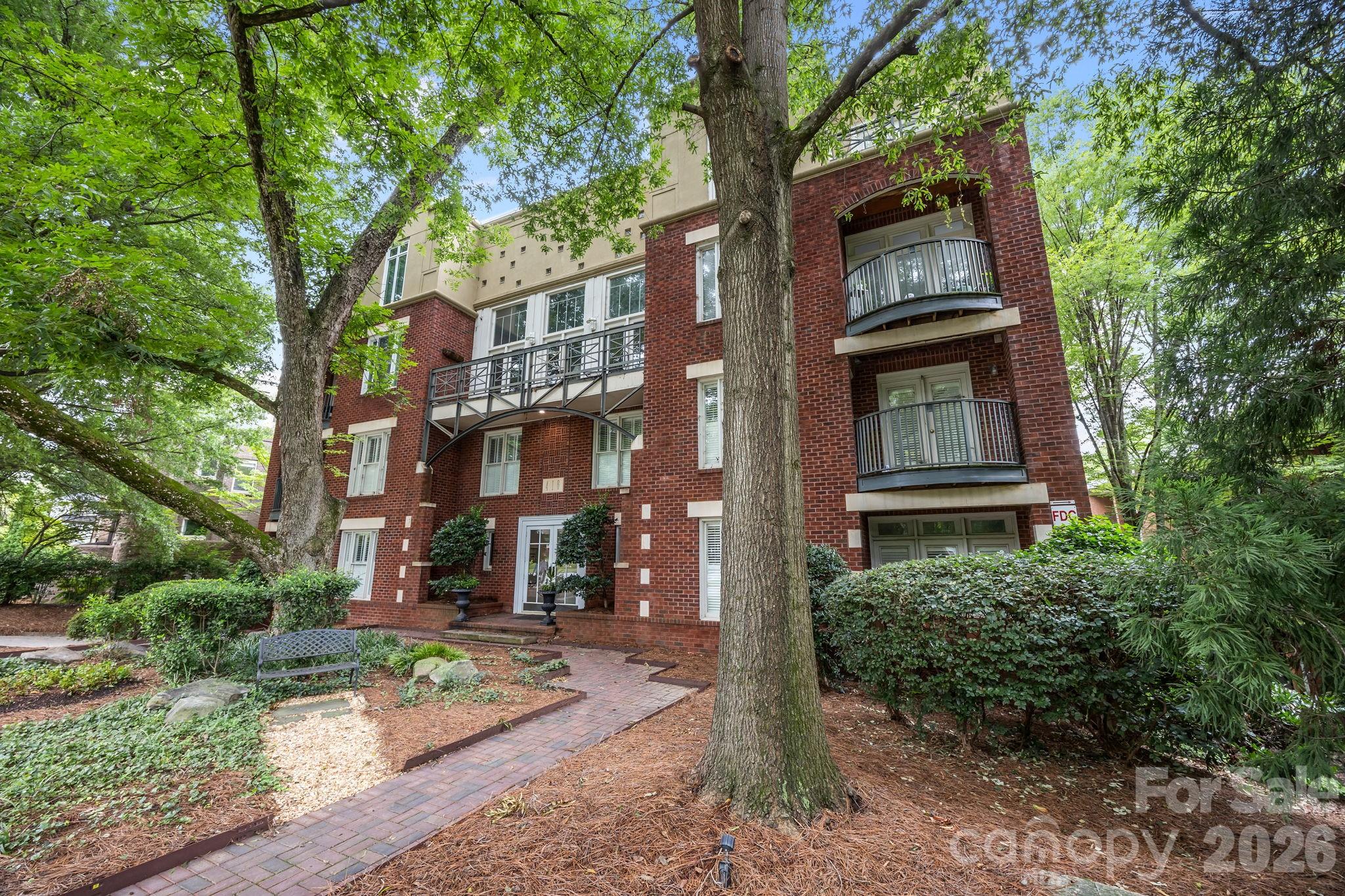 Charming 2 bedroom top story unit on Queens Road in the heart of the sought-after Myers Park neighborhood!  Very close proximity to renowned hospitals and easy commute to Uptown! NEWLY REMODELED KITCHEN...NEW cabinetry, under-mount sink and New Quartz Counter tops!...Hardwood floors in main living area crown molding, fireplace w/gas logs, half bath on main, stainless steel appliances, Two private outdoor terraces—one on each floor (one off the Primary BR and the other off the LR), Vinyl Plank style flooring added in hall and in bedrooms on 2nd level. The primary bedroom boasts a walk-in closet, en-suite bathroom. Secure gated garage parking  with rare 2 assigned spaces for unit 19 , storage closet, secured building with elevator, …Fantastic location with abundant dining and entertainment options , with theaters, parks, and cultural attractions.