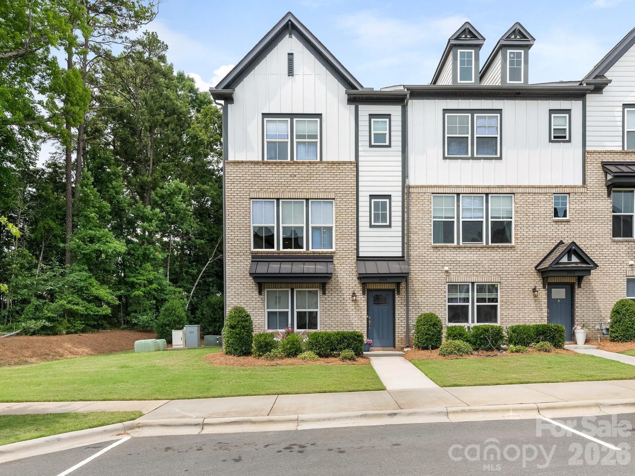 Lower level mentioned in SF is actually 4th level conditioned storage.  

Experience elevated living in this exceptional 4-level end-unit townhome, ideally situated in the desirable area of Ballantyne. Surrounded by mature trees and lush greenery, this residence offers a rare combination of privacy, sophistication, and natural beauty, with expansive windows that fill the home with abundant natural light.
The main level features a private guest retreat with a full bath, creating an ideal space for visitors, multigenerational living, or a quiet home office.  The second level is thoughtfully designed for both everyday living and elegant entertaining. Rich hardwood floors extend throughout the common living areas, enhancing the home's warmth and sophistication. A spacious living room with a fireplace flows seamlessly into the dining area and gourmet kitchen, where an oversized island with seating for four, beverage center, and dedicated home management space combine style and functionality. Just off the kitchen, a private balcony provides the perfect setting for morning coffee or evening relaxation while overlooking the tranquil wooded surroundings. A versatile bonus space offers endless possibilities as a home office, walk-in pantry, or customized storage area, while a powder room completes the level.  The third level is dedicated to luxurious private living, featuring two generously sized bedroom suites, each with its own ensuite bath, creating a true retreat for residents and guests alike. A conveniently located laundry area completes this level.  At the pinnacle of the home, a spectacular rooftop sky terrace designed for year-round enjoyment. Complete with a built-in fireplace and surrounded by serene treetop views, this outdoor sanctuary offers an extraordinary setting for entertaining, relaxing, or enjoying breathtaking sunsets.  With its premium end-unit location, sophisticated design, and peaceful natural surroundings, this residence delivers a refined lifestyle in the heart of Ballantyne, just moments from premier shopping, dining, and everyday conveniences.