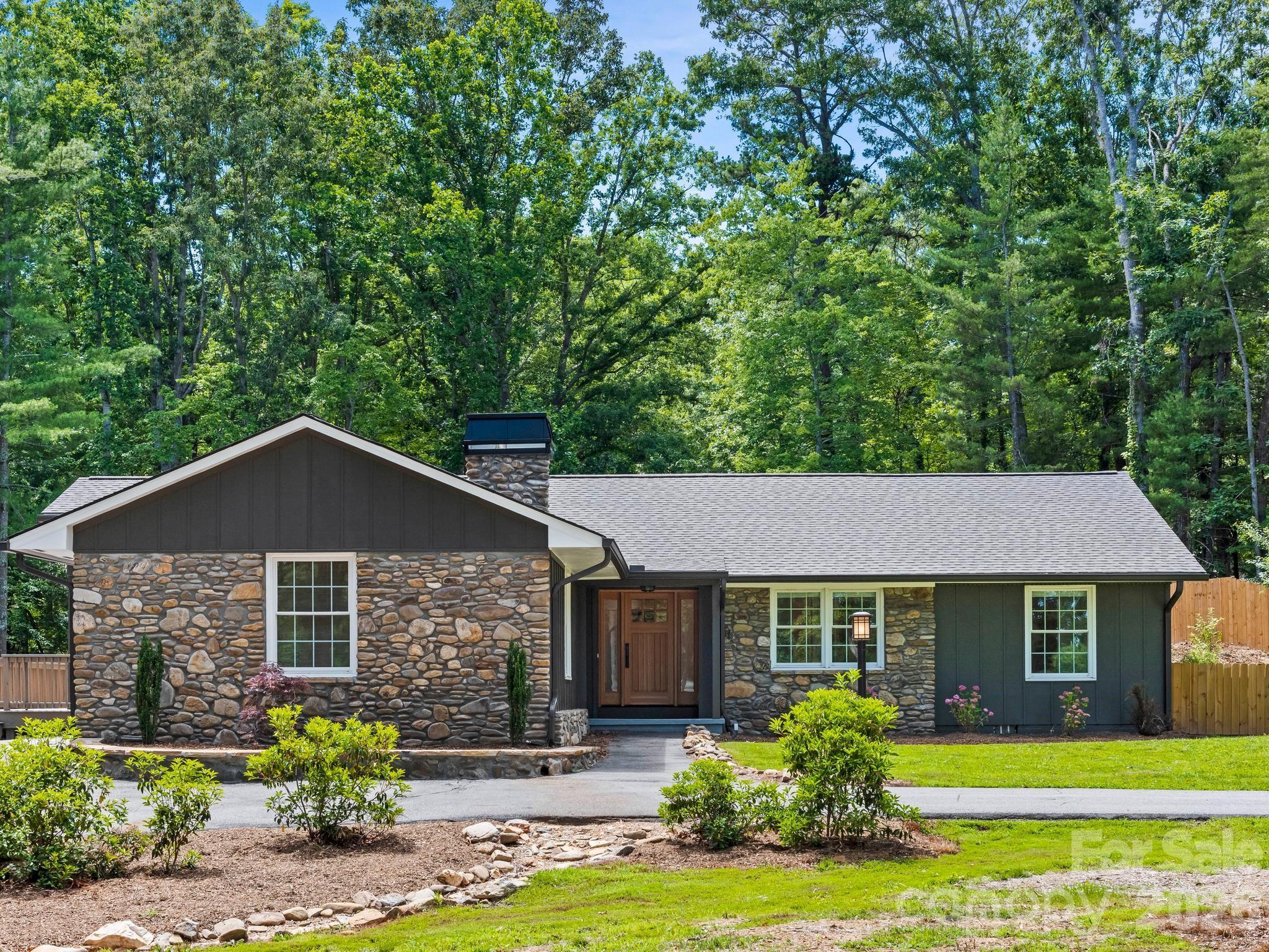 Welcome to Glen Arden Estates, where privacy, quality, & convenience come together on a beautifully usable one-acre lot nestled on a quiet, no-through street in one of South Asheville's most desirable locations.
This fully renovated home offers 3 bedrooms, 3 full baths, & a dedicated office, all thoughtfully designed with an open floor plan, beautiful hardwood floors, generous-sized bedrooms, & ceiling fans throughout. The stunning kitchen is the heart of the home, featuring new granite countertops, stainless steel appliances, bar seating, & a direct-vented hood.  Gather in the inviting sitting area centered around a new wood-burning fireplace or step outside to the spectacular 355-square-foot screened porch complete with Trex decking, a vented gas log fireplace, ceiling fan, & propane stub for grilling - perfect for year-round entertaining.
The outdoor living spaces are exceptional, boasting over 1,700 square feet of patio space surrounding a heated in-ground pool & a fully fenced backyard designed for relaxation & recreation. A detached storage shed with electricity provides ample workspace or storage & includes prewired solar panels currently stored inside.  Additional features include a two-car garage with utility sink & durable mocha-stained floors, 3 beautifully renovated bathrooms with timeless tile finishes, a fully encapsulated crawlspace with an industrial dehumidifier, & new roof and HVAC systems for peace of mind.
Located in highly sought-after school districts with abundant parking & a circular drive, this is the rare home that truly checks all the boxes.