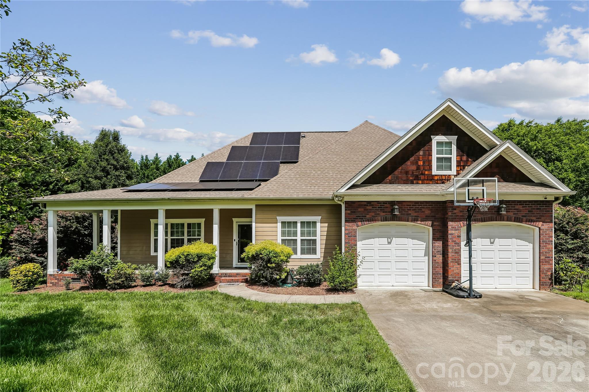 Welcome home to this beautifully renovated 5-bedroom, 4.5-bathroom residence offering exceptional versatility, modern upgrades, and timeless charm. Situated on a desirable corner lot in Charlotte near the UNCC campus, this spacious home features a welcoming wraparound porch, soaring ceilings, and an open-concept layout designed for comfortable everyday living and entertaining. Energy-efficient solar panels are already installed. At the heart of the home is the stunning chef’s kitchen, complete with an extended island featuring a sitting area, abundant workspace, and seamless flow into the main living areas. Elegant archways enhance the openness and character throughout the home, while the enclosed sunroom just off the kitchen provides the perfect space to relax year-round. The thoughtfully designed main level includes a luxurious primary suite with an ensuite bath, along with a flexible bonus room ideal for a home office, den, craft room, or additional sitting area. Two additional bedrooms and a full secondary bath are also conveniently located on the main floor. Upstairs, you’ll find a spacious multi-purpose loft area complete with a full bath, offering endless possibilities as a guest suite, recreation room, media room, or additional bedroom space. An impressive addition to the home creates a separate living area perfect for multigenerational living, guest accommodations, or private retreat space. This addition includes a half bath on the main level, while the upper level features the fifth bedroom and an additional full bath. Venture outside to enjoy the Trex deck patio overlooking the fenced backyard with mature tree-lined privacy, creating a tranquil outdoor oasis perfect for gatherings or relaxing evenings at home. With abundant space, flexible living options, premium renovations, energy-efficient features, exceptional outdoor living, and a prime Charlotte location, this one-of-a-kind property offers the perfect blend of comfort, functionality, and style.