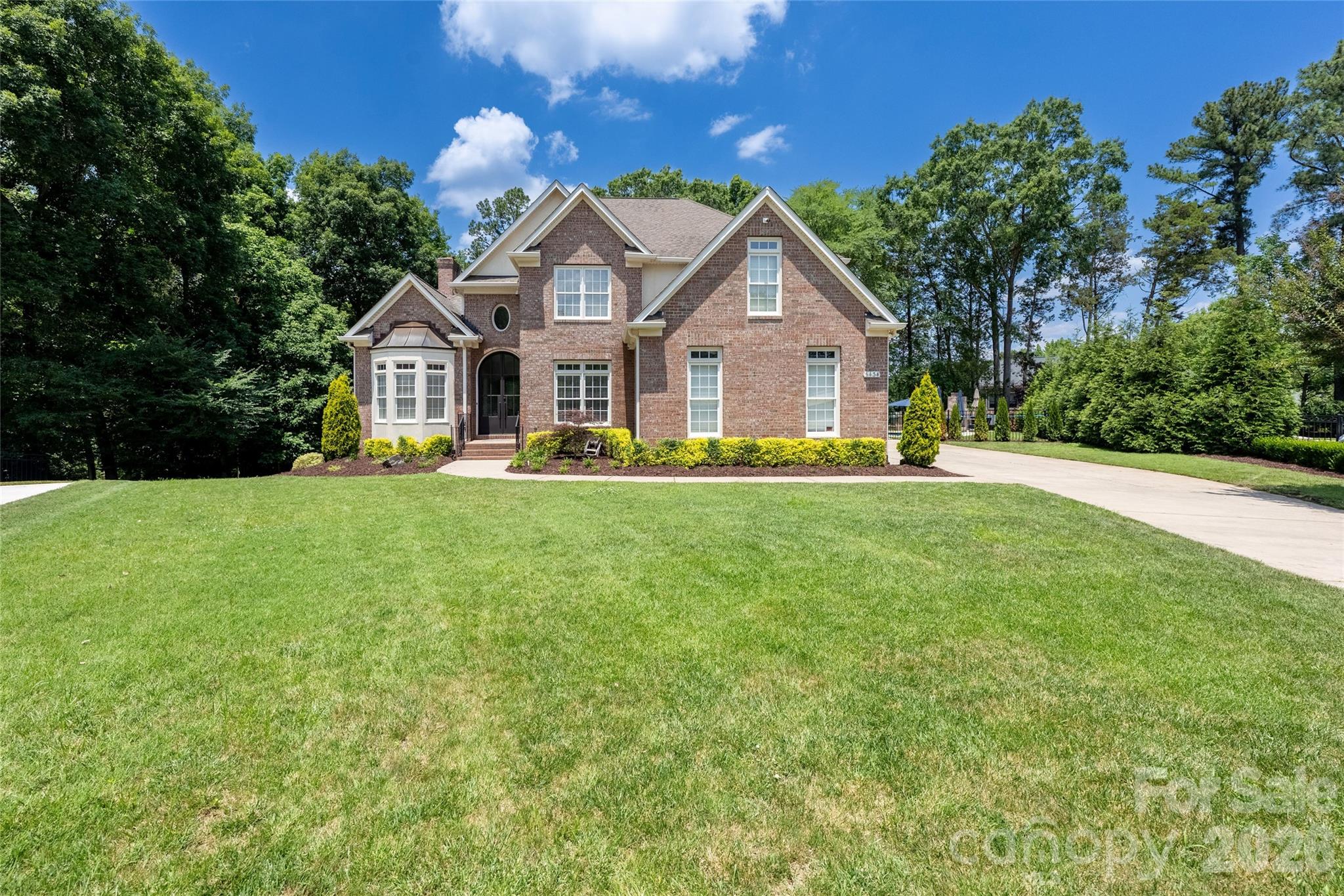 This stunning home on a private .82-acre cul-de-sac lot offers resort-style living with a sparkling new 32' x 15' saltwater heated pool, travertine decking, a complete outdoor kitchen + fireplace, and a spacious 3-car garage. Step inside through the dramatic new 12-foot steel front door and discover modern luxury throughout, including a chef’s kitchen with a Sub-Zero refrigerator, dedicated beverage/wine fridge, and Café double oven. Meticulously updated from top to bottom, the home features new hardwood floors throughout, custom kitchen cabinets and quartz countertops, fully renovated bathrooms, a dedicated home office, new stairs and spindles, and 10-foot bifold doors leading to the enclosed screened porch. The fully fenced, re-landscaped backyard provides exceptional privacy and space for entertaining, complete with a charming tree house. Additional highlights include new carpet in the upstairs bedrooms and generous living spaces. Ideally located in South Charlotte with easy access to the Arboretum, top dining and shopping, and excellent schools including Olde Providence Elementary, Carmel Middle, and South Mecklenburg High. This move-in-ready home perfectly blends timeless charm with modern luxury.