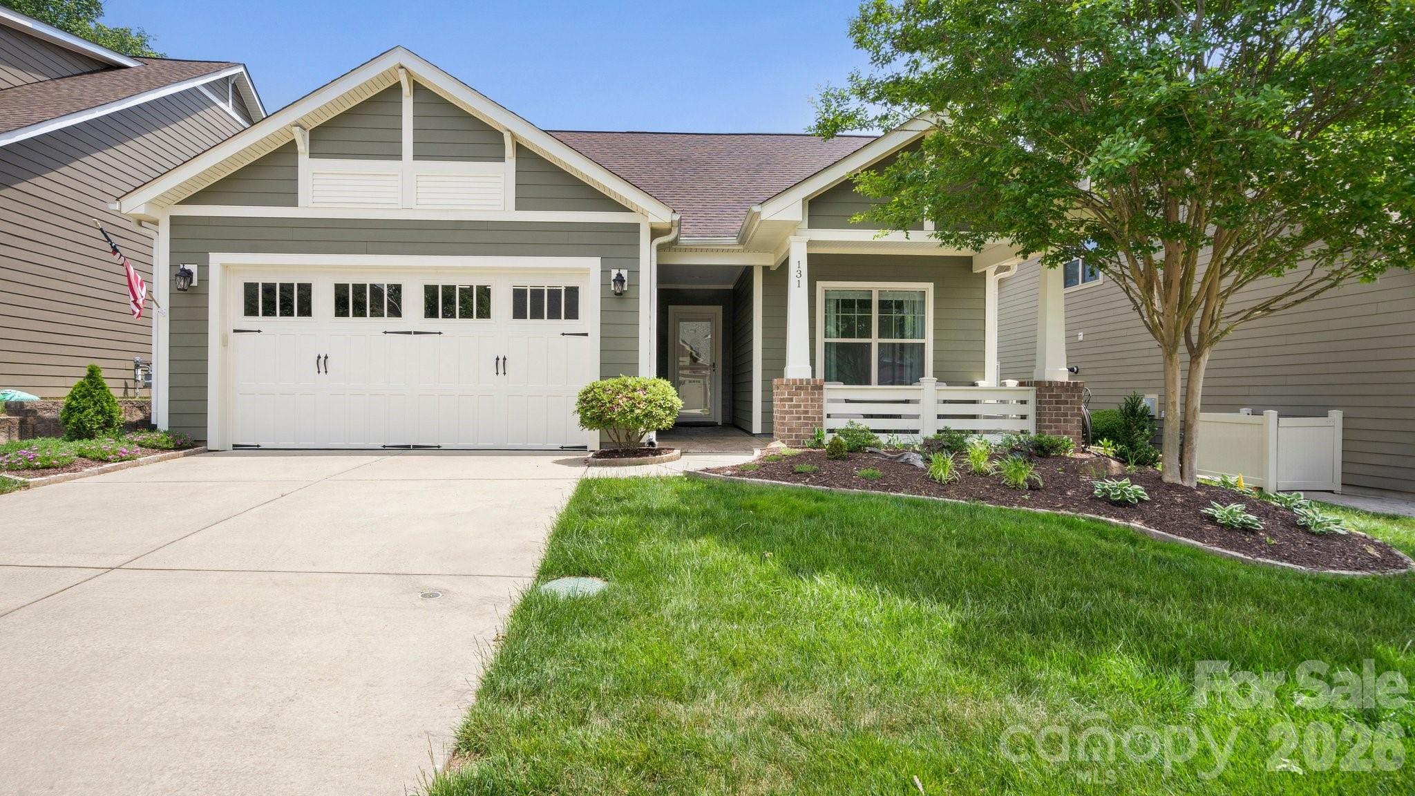 Make yourself comfortable, wave to the neighbors and & sip your favorite beverage on the spacious front porch. This open concept home features 10' ceilings, 8' doors and flows seamlessly outside from the great room to your backyard oasis. Glide across the Travertine flooring from the screened Lanai to the serene back patio w/arbor, grilling area & gas firepit extending in & outdoor entertaining options. Well-appointed kitchen anchors the main living area & includes new Quartzite counter tops, SS appliances including refrigerator and updated tile backsplash. Dining area features additional custom cabinetry and serving/bar area. Primary suite is highlighted with a built in window seat adding storage and versatility. Recently updated ensuite bath features a dual sink vanity with make up area, Quartz counter tops, tiled shower with frameless rain glass doors & a generous custom walk-in closet that connects to the laundry room with washing machine and dryer. New LVP flooring throughout the home (No carpet) for easy maintenance. Recirculating line for instant hot water in primary bath and water filtration system at kitchen sink. 2 car garage w/4' extension, sink & extensive hanging storage rack system. Walking distance to the Twin Mills Club. Trilogy Membership includes Freedom Boat Club on Lake Norman plus award winning amenities.