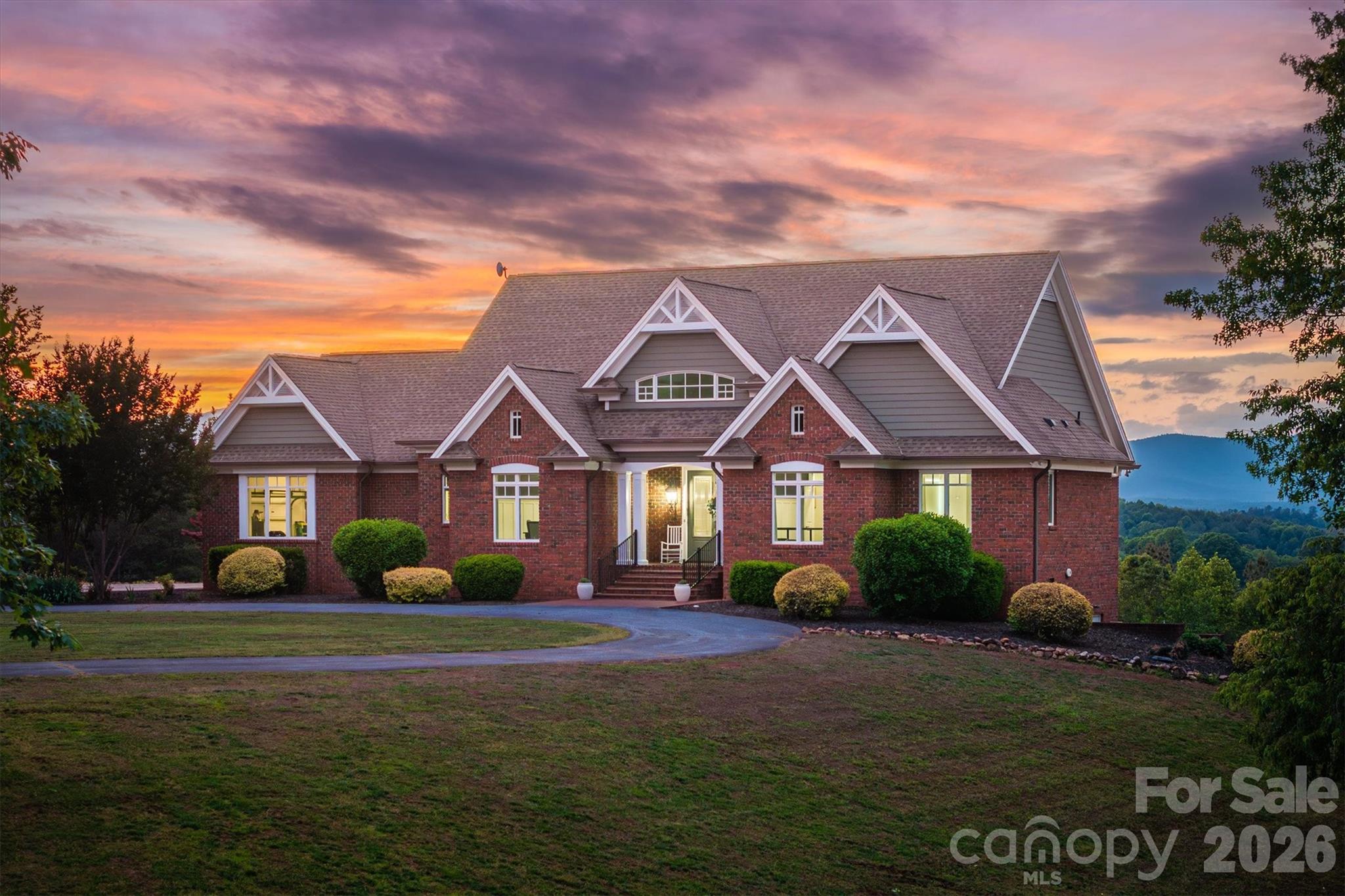 Experience unparalleled serenity on this expansive estate spanning nearly 27 acres, offering a perfect blend of luxury and natural beauty. This meticulously designed home features over 3,300 sq ft of refined living space, including 3 bedrooms, 3.5 baths, flex space, and fully finished basement. The heart of the home is a stunning chef’s kitchen complete with sleek white cabinetry, premium appliances, and a custom range hood. Elegant interior details continue throughout, from the formal dining room with classic wainscoting to the soaring vaulted ceilings and majestic stone fireplace in the living area. Large windows throughout the home, such as those in the breakfast nook , living room, and primary suite, frame breathtaking, long-range mountain views. The primary bathroom serves as a luxurious retreat, meticulously designed with high-end finishes and thoughtful amenities. Leading into the bathroom is a hallway flanked by separate "his and her" walk-in closets, providing organized and private storage space before entering the main bath area. The space features a stunning dual vanity with dark wood cabinetry and modern vessel sinks, complemented by a large, backlit LED mirror that provides optimal lighting. A contemporary, deep freestanding soaking tub and custom walk-in shower, continues the wood-look tile theme on the walls, paired with elegant marble-patterned flooring and a built-in niche for essentials. The bathroom includes a private water closet and ample storage within the vanity.  Stepping down to the fully finished basement is an entertainer's dream, featuring a living room, a convenient wet bar area and additional storage. Each lower-level bedroom provides ultimate privacy with its own dedicated full bath. Step outside to find an outdoor oasis designed for relaxation. The expansive back deck and brick patio provide the ideal vantage point for taking in the "amazing views" and enjoying the fresh air. Located just minutes from Lake James, this property offers a rare opportunity to own a private retreat with modern comforts, timeless appeal, and panoramic views. Dont miss your chance to own this rare 27 acre sanctuary where luxury living meets the quiet beauty of the foothills and endless mountain horizons.  Minutes to Lake James State Park!