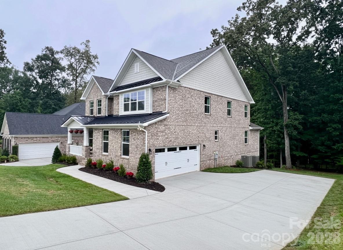 This custom-built luxury home offers over 5,500 square feet of thoughtfully designed living space, featuring a highly desirable primary suite and five additional bedrooms, providing flexibility for families, guests, or multi-generational living.

The grand primary suite is conveniently located on the second level and features a spacious sitting area along with a spa-inspired bath. Upstairs and throughout the home, generously sized secondary bedrooms offer comfort and privacy, while a private third-floor retreat with a full bath creates the perfect guest or bonus space.

Designed for both everyday living and entertaining, the chef’s kitchen is equipped with quartz countertops, a gas cooktop, butler’s pantry, and a mini bar refrigerator. The finished walkout basement expands your living space with a bedroom with full bath, game room and sunroom, opening to a private, wooded backyard with serene lake views.

Situated on city water and sewer, this home combines convenience with peace of mind. The all-brick exterior offers timeless appeal and low-maintenance living, and the home includes a 10/2/1 builder warranty.

Located in Norman Pointe, a walkable community that feels tucked away yet remains convenient to everything Denver has to offer, this home delivers the best of both worlds—privacy and accessibility. Denver is widely considered one of Lake Norman’s hidden gems, offering plenty to do with noticeably less traffic than other Lake Norman towns.

Just minutes from a public boat ramp and a short drive to Charlotte, this location makes commuting easy while still allowing you to enjoy a relaxed, lake-focused lifestyle every day.