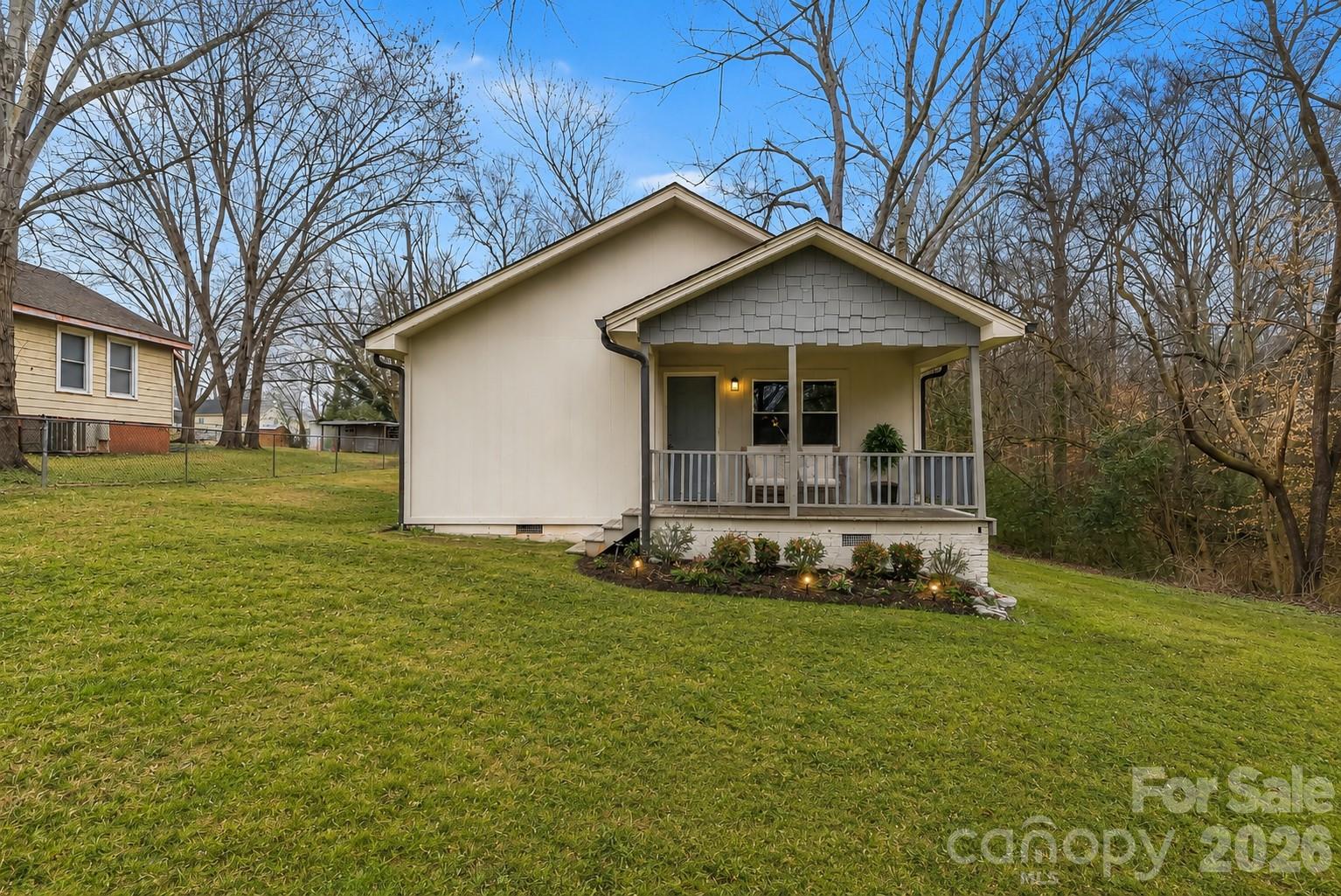 Charming and refreshed 1920 bungalow available in Stanley! This cozy home offers peaceful, private one-level living at the end of a dead-end road - combined with convenient shopping and dining close by, and less than 20 minutes to the Whitewater Center and less than 30 to Charlotte-Douglas Airport. Enjoy the recent cosmetic updates including brand new floors, plus peace of mind is yours with roof and HVAC updates in 2022. Three bedrooms and two bathrooms provide plenty of space, with a laundry/mud room for convenience and storage, and a well-appointed kitchen with stainless steel appliances. Relax on the rocking-chair front porch or in the backyard around the fire pit with family and friends. Come see this home today!